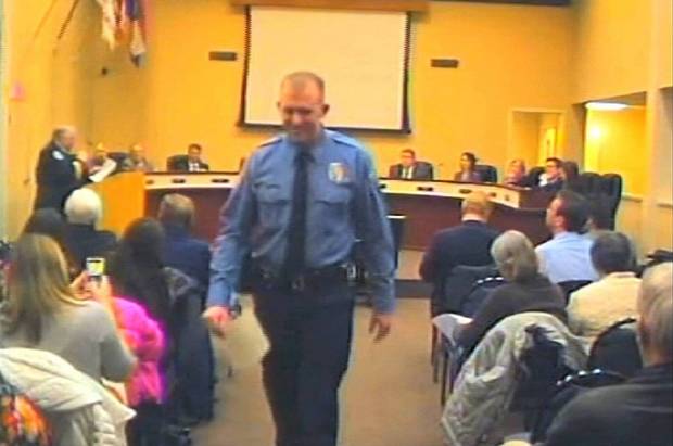 In this Feb. 11, 2014 image from video released by the City of Ferguson, Mo., officer Darren Wilson attends a city council meeting in Ferguson. (AP/City of Ferguson)