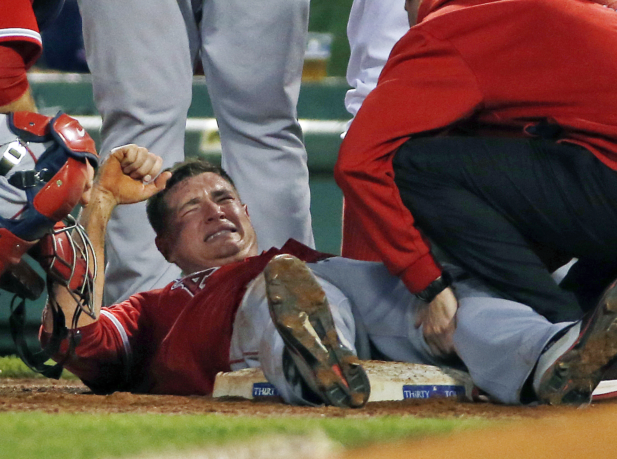 Los Angeles Angels starting pitcher Garrett Richards grimaces as he is attended to on the field after an injury during the second inning of a baseball game against the Boston Red Sox at Fenway Park in Boston, Wednesday, Aug. 20, 2014. (AP Photo/Elise Amendola) (AP)