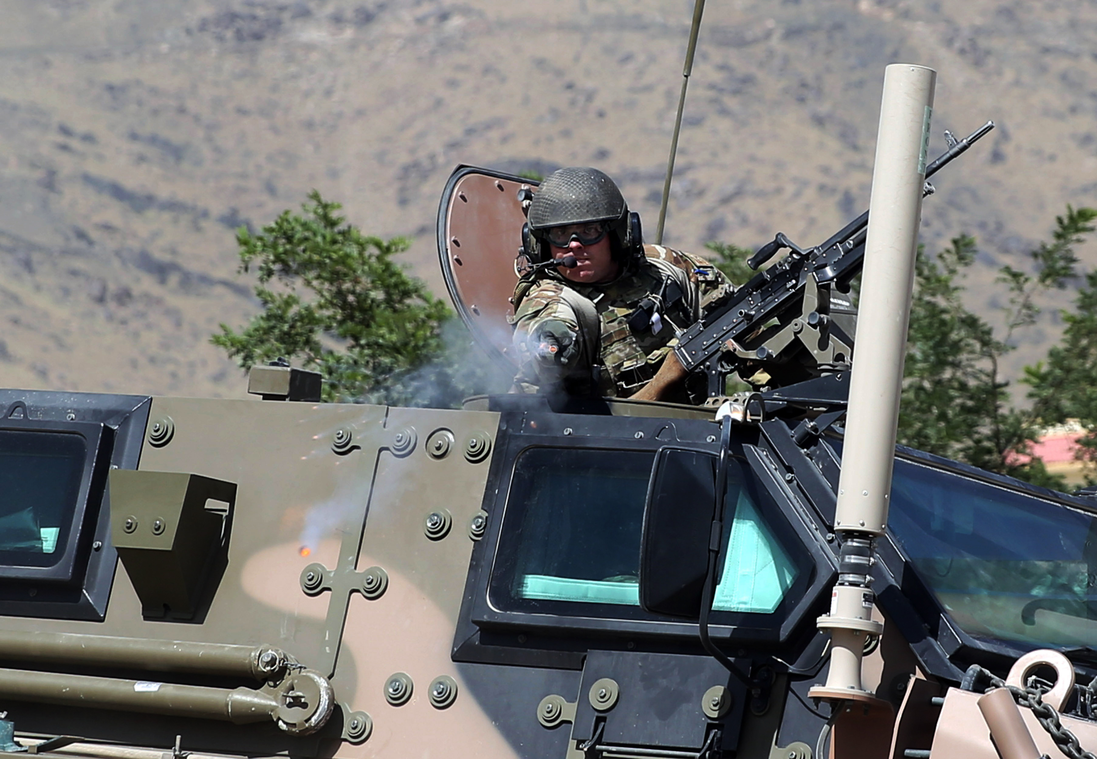 A NATO soldier opens fire in an apparent warning shot in the vicinity of journalists near the main gate of Camp Qargha, west of Kabul, Afghanistan, Tuesday, Aug. 5, 2014. Earlier in the day, a man dressed in an Afghan army uniform opened fire on foreign troops at the military base, killing a U.S. two-star general and wounding others, among them a German brigadier general and a number of Americans troops, authorities said. (AP Photo/Massoud Hossaini) (AP)
