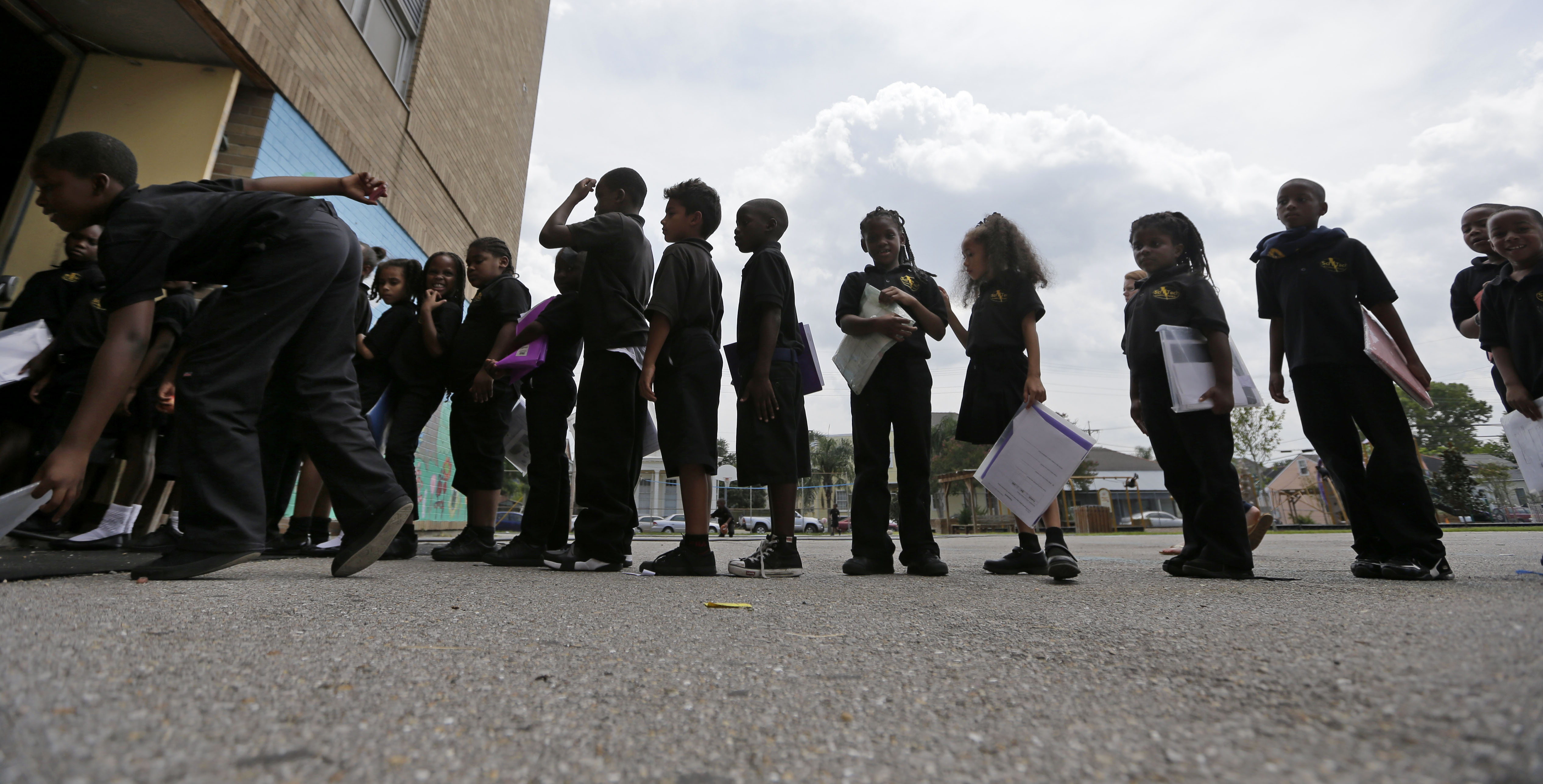 Students wait in line at ReNEW SciTech Academy, a charter school in New Orleans, Thursday, Aug. 14, 2014. Nine years after Hurricane Katrina, charter schools are the new reality of public education in New Orleans. The vast majority of public school students will be attending a charter school established by a state-run school district created in the wake of the storm. (AP Photo/Gerald Herbert) (AP)