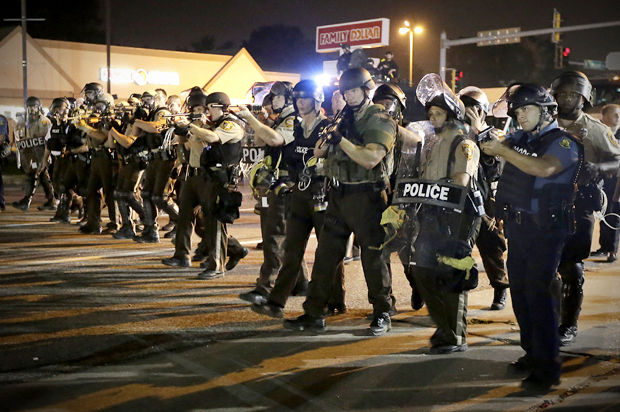Police advance to clear people, Aug. 18, 2014, during a protest in Ferguson, Mo. (AP/Charlie Riedel)