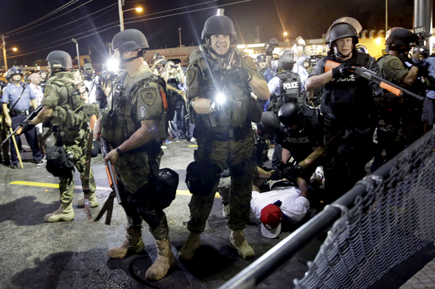A man is arrested as police try to disperse a crowd during protests in Ferguson, Mo., Aug. 20, 2014. (AP/Jeff Roberson)