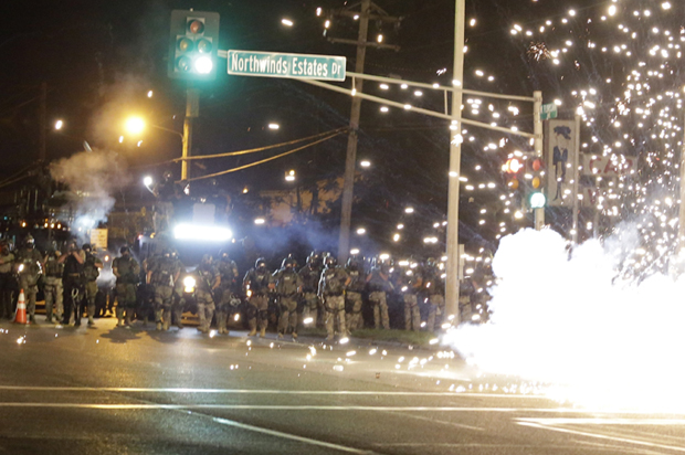 A device deployed by police goes off in the street as police and protesters clash Wednesday, Aug. 13, 2014, in Ferguson, Mo. (AP/Jeff Roberson)