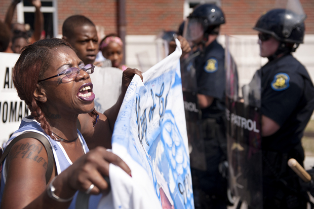 Marcelle Stewart confronts police officers during a march and rally in downtown Ferguson, Mo., Aug. 11, 2014. (AP/Sid Hastings)