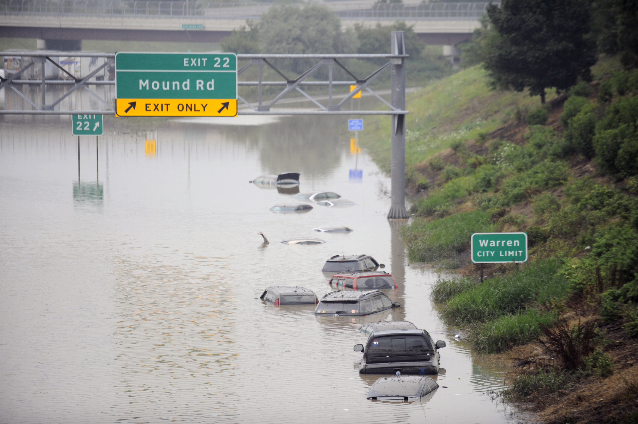 Cars are stranded along a flooded stretch of I-696 at the Warren, Mich. city limits Tuesday morning, Aug. 12, 2014. (AP Photo/Detroit News, David Coates)