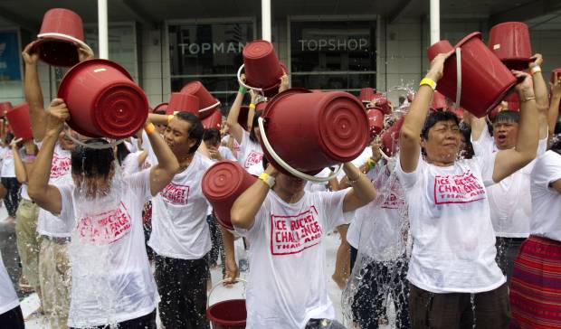 People pour ice water over themselves during an "ice bucket challenge" fund raising event in Bangkok (AP Photo/Sakchai Lalit)