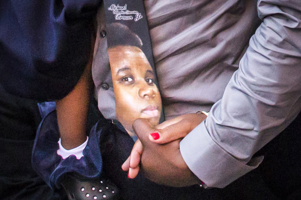 An image of Michael Brown is seen on a tie worn by his father, at the Friendly Temple Missionary Baptist Church in St. Louis, Missouri, August 25, 2014. (Reuters/Adrees Latif)