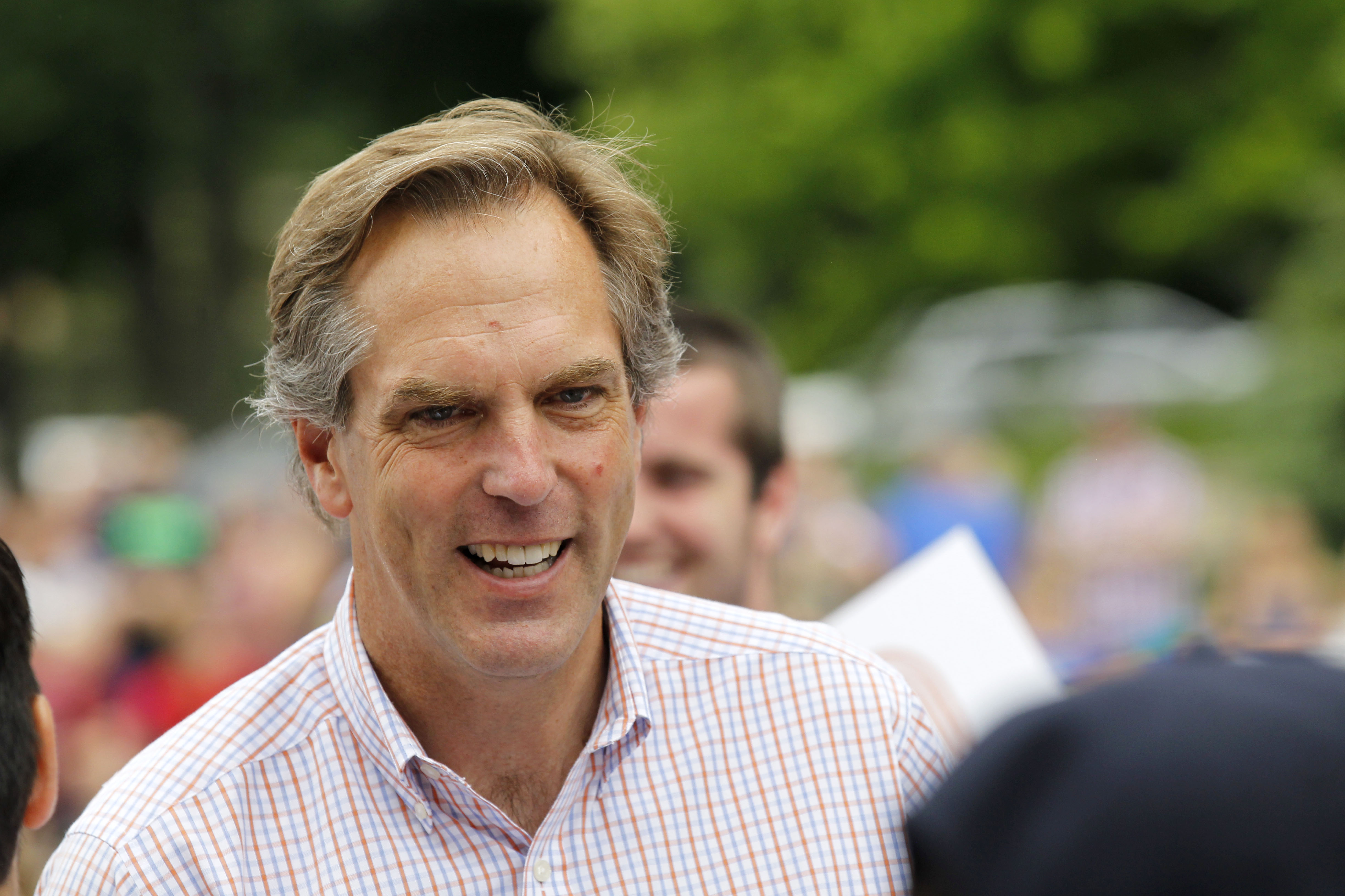 In this Friday, July 4, 2014 photo, Republican U.S. Senate candidate Mike McFadden talks with parade-goers during the Fourth of July parade in Delano, Minn. In 2012, McFadden's investment firm was involved in a merger that moved an American pharmaceutical company to Ireland and significantly dropped its tax rate. Inversions are legal, but politicians are calling for a clampdown - including McFadden. (AP Photo/Ann Heisenfelt) (AP)