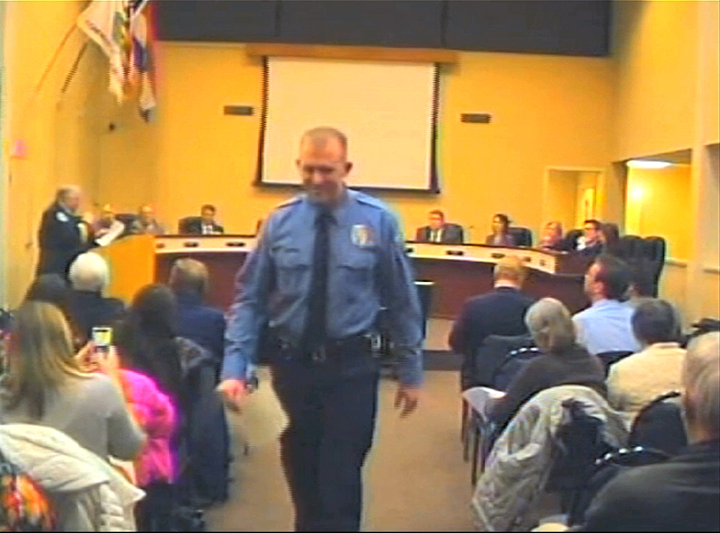 In this  Feb. 11, 2014 image from video released by the City of Ferguson, Mo., officer Darren Wilson attends a city council meeting in Ferguson. (AP/City of Ferguson)