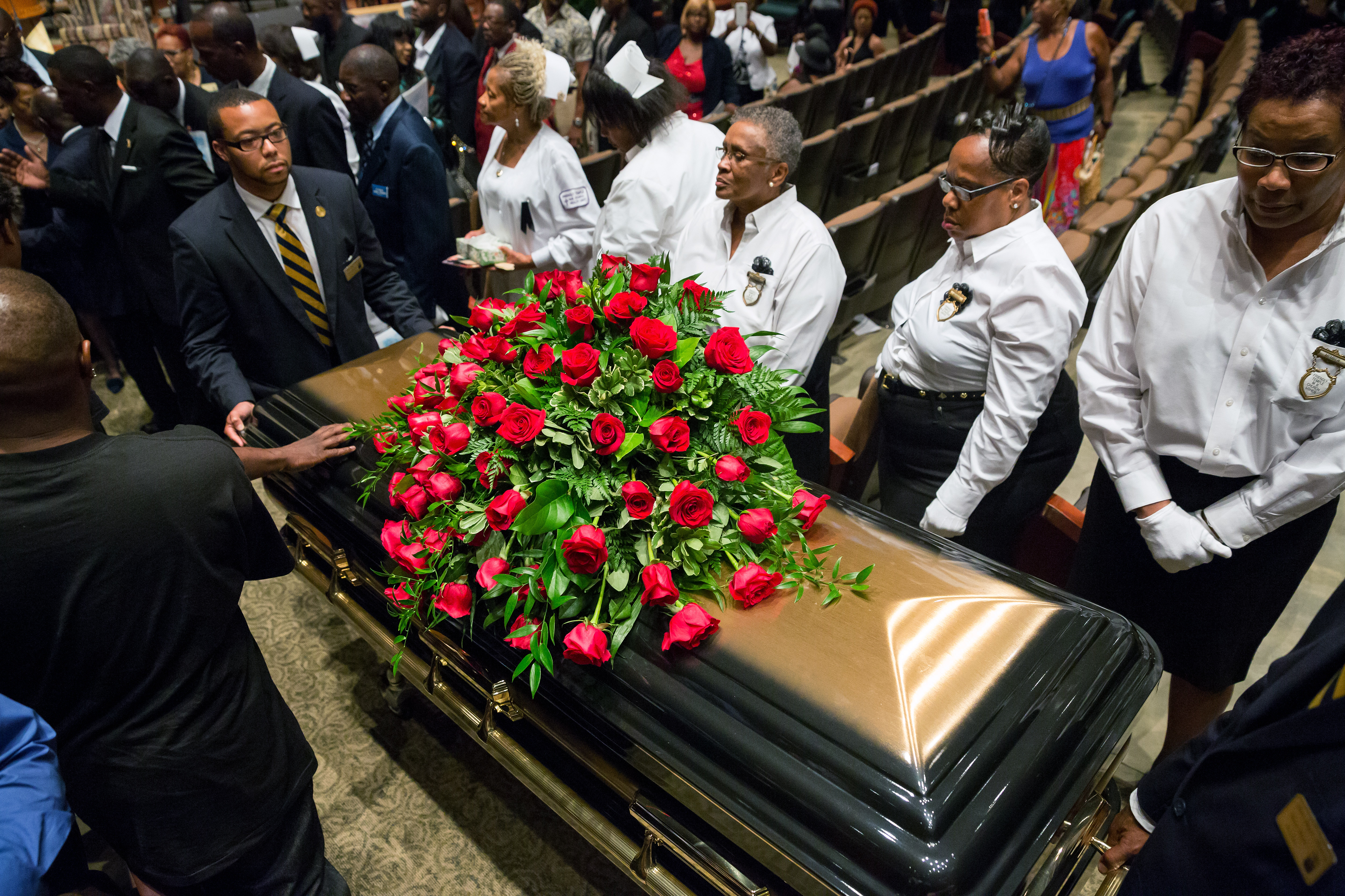 A casket containing the body of Michael Brown is wheeled out Monday, Aug. 25, 2014, at Friendly Temple Missionary Baptist Church in St. Louis. Hundreds of people gathered to say goodbye to Brown, who was shot and killed by a Ferguson, Mo., police officer on Aug. 9. (AP Photo/New York Times, Richard Perry, Pool) (AP)
