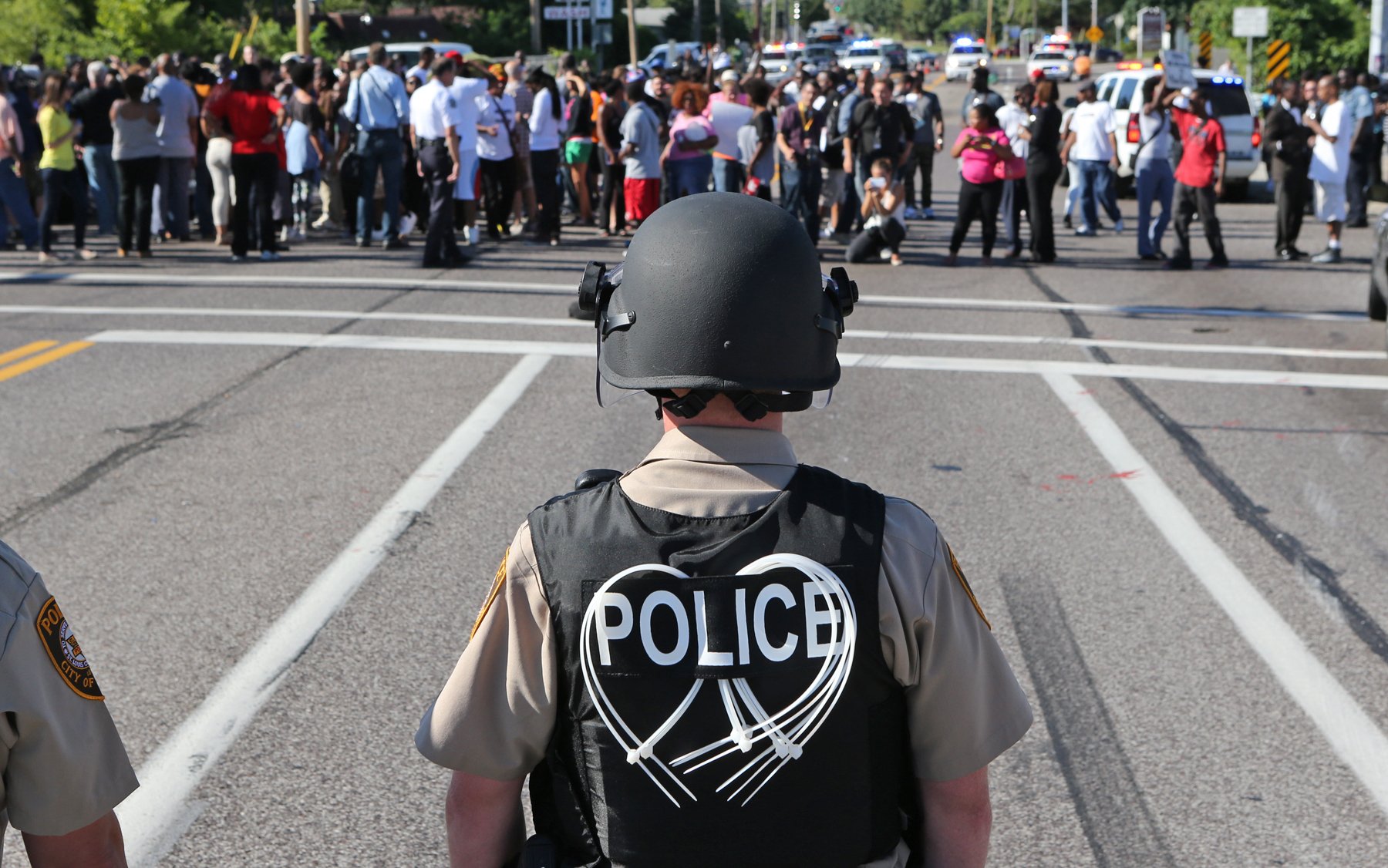 A line of police waits for demonstrators in Ferguson, Mo., Aug. 13, 2014. (AP/J. B. Forbes)