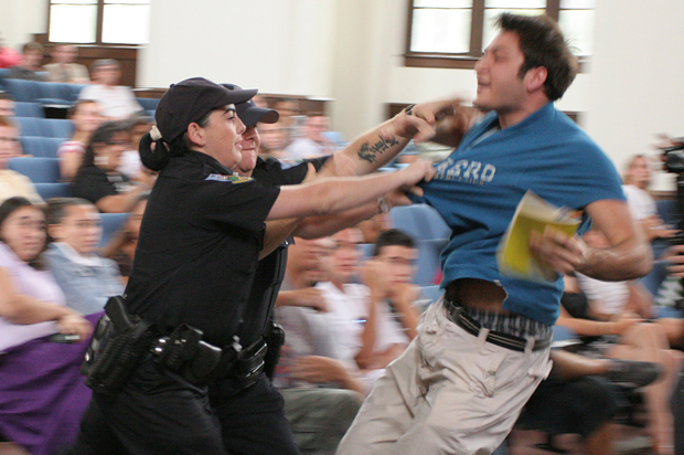 University of Florida student Andrew Meyer struggles with University Police as they try to remove him from a question and answer session with John Kerry, Sept. 17, 2007, in Gainesville, Fla. Meyer was Tasered and arrested. (AP/Andrew Stanfill)