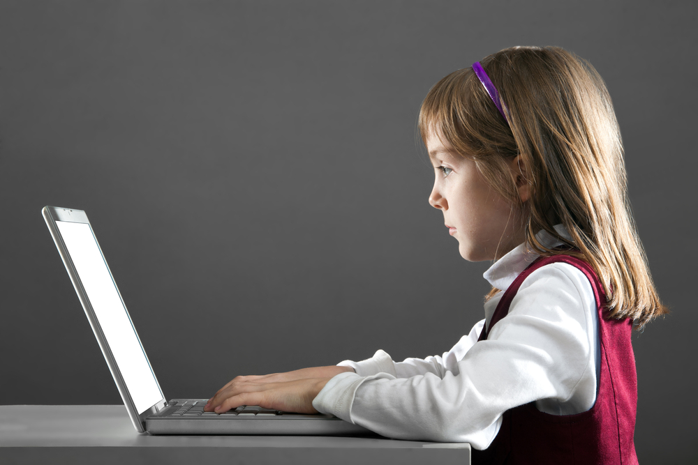 Little girl with computer (<a href='http://www.shutterstock.com/gallery-342925p1.html'>Alexander Mak</a> via <a href='http://www.shutterstock.com/'>Shutterstock</a>)