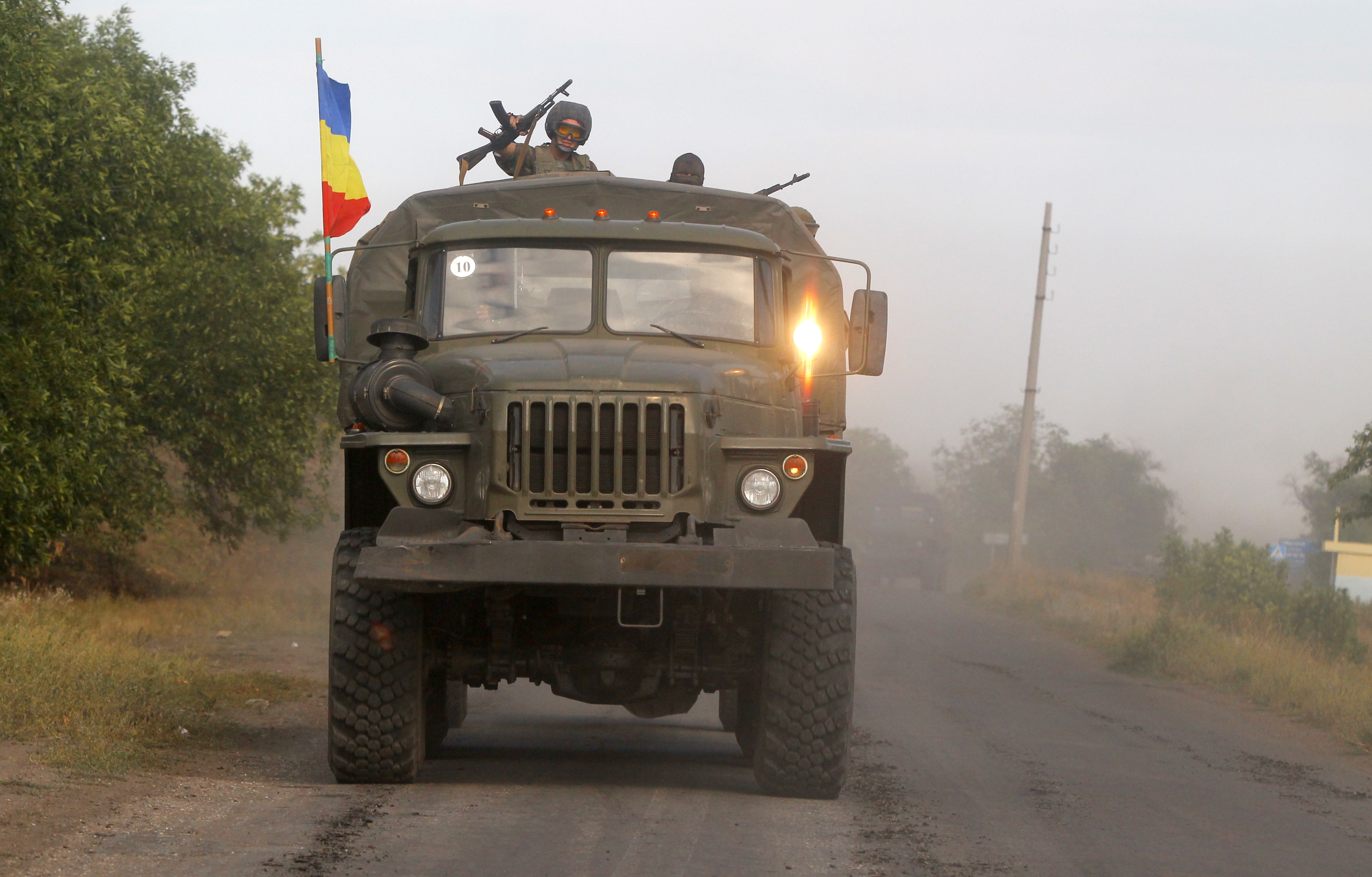 Pro-Russian rebels ride on a truck in the town of Krasnodon, eastern Ukraine, Sunday, Aug. 17, 2014. A column of several dozen heavy vehicles, including tanks and at least one rocket launcher, rolled through rebel-held territory on Sunday.(AP Photo/Sergei Grits) (AP)