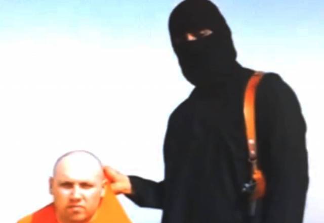 This still image from an undated video released by Islamic State militants on Tuesday, Aug. 19, 2014, purports to show journalist Steven Sotloff being held by the militant group. (Associated Press)