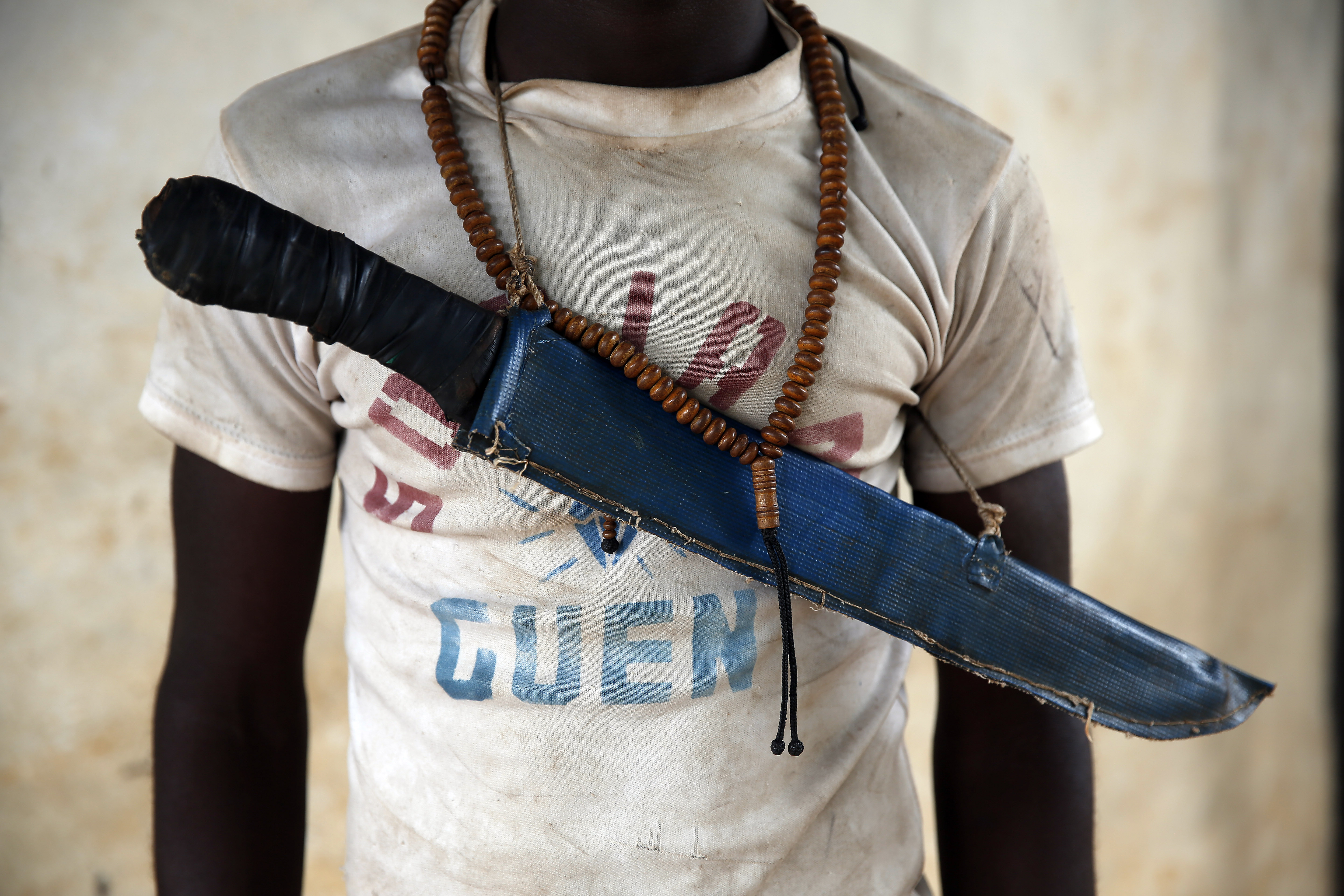 In this April 15, 2014 photo, an Anti-Balaka Christian fighter stands on the front of a looted Muslim store in Guen, some 250 kilometers north of Bangui, Central African Republic. As U.N. peacekeepers prepare to go into the Central African Republic to take over a regional mission, the death toll since fighting between Muslims and Christians started in December underscores how the aid is coming too late for thousands of victims. (AP Photo/Jerome Delay) (AP)