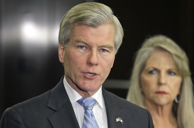 Bob McDonnell makes a statement as his wife, Maureen, listens during a news conference in Richmond, Va., April 24, 2014. (AP/Steve Helber)