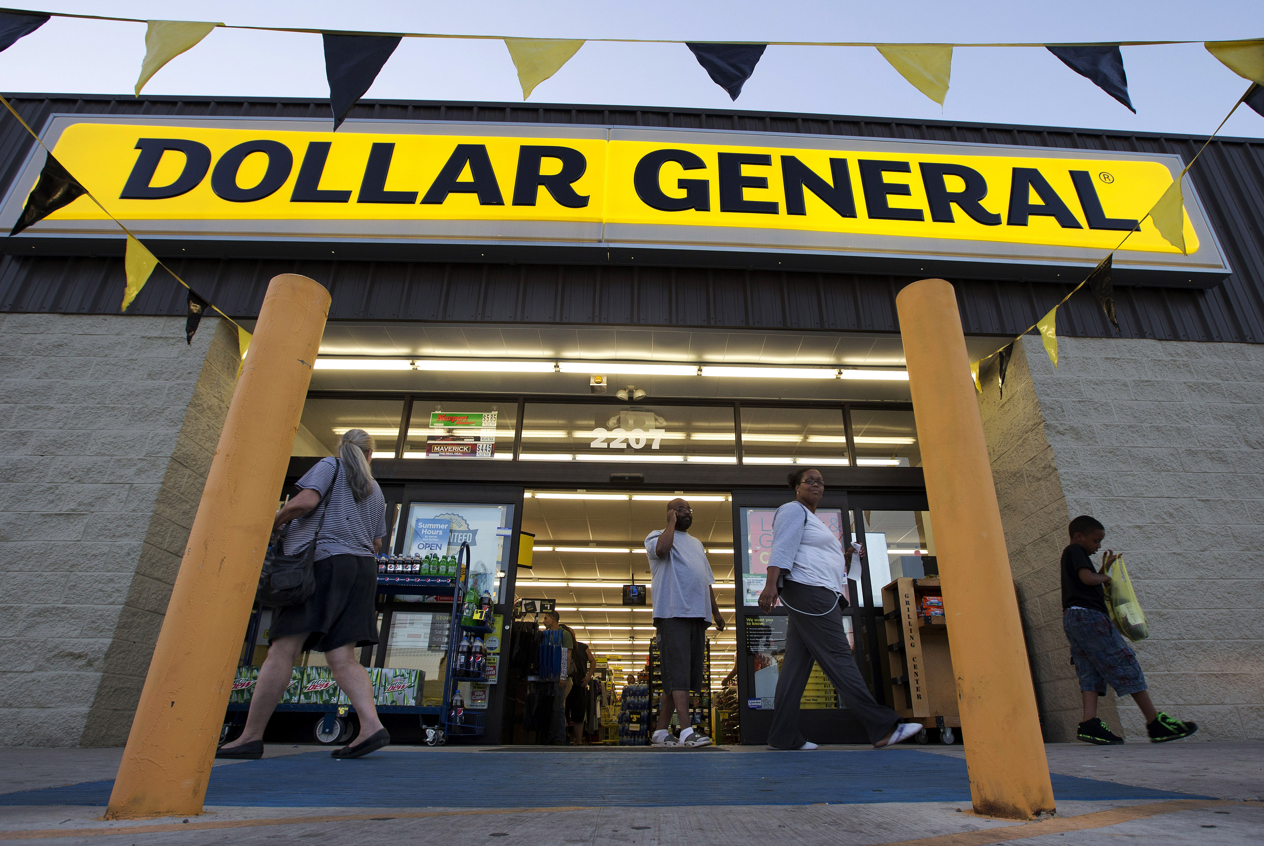 FILE - In this Wednesday, Sept. 25, 2013, file photo, customers exit a Dollar General store, in San Antonio. Dollar General is going hostile with its $9.1 billion bid for Family Dollar after repeated rejections of previous offers by its rival. The discount chain said Wednesday Sept. 10, 2014 that it is offering investors of Family Dollar Inc. $80 per share in cash, the same offer that was rejected last week by the company board. (AP Photo/Eric Gay, File) (AP)