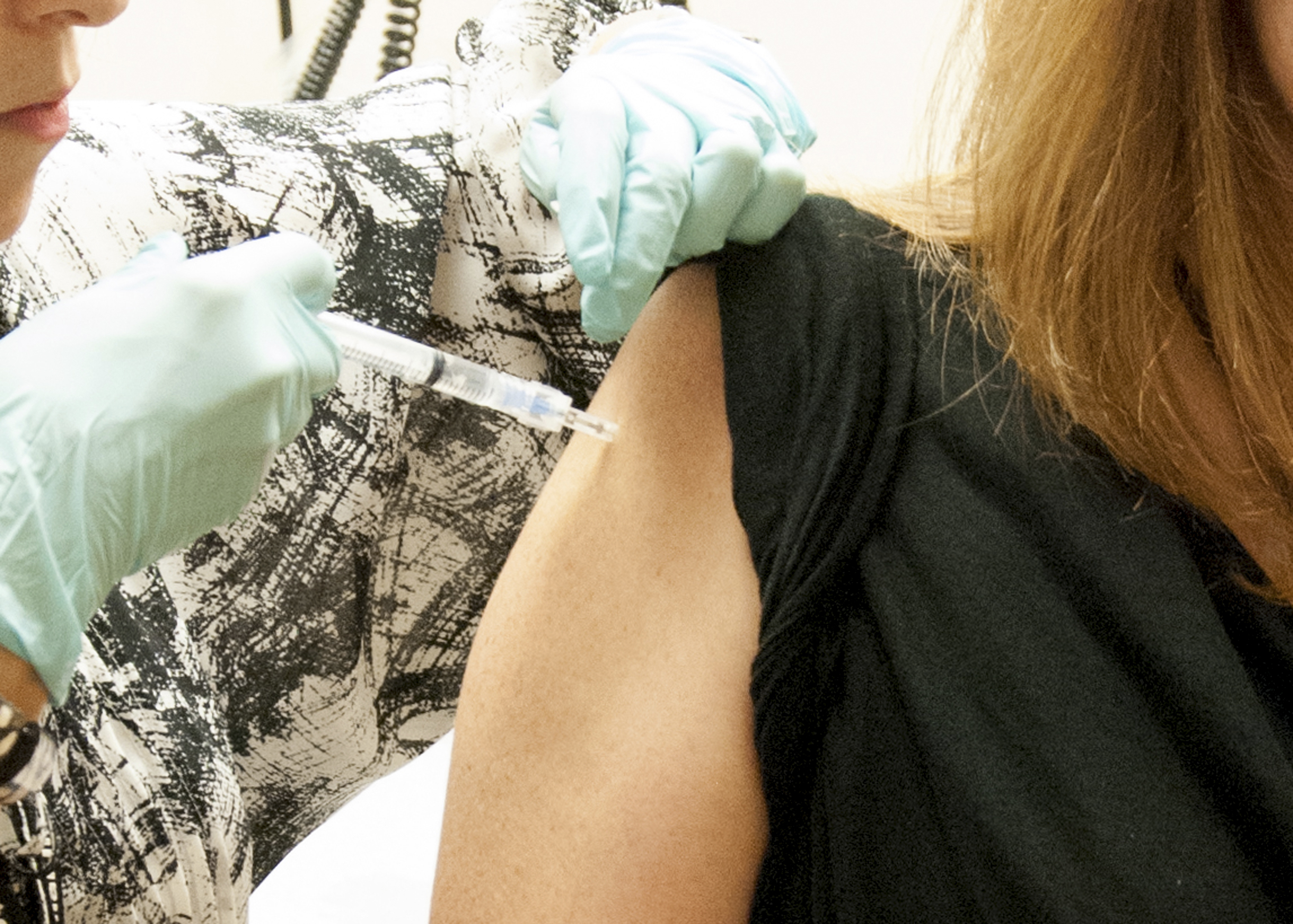 FILE - This handout  file photo taken Sept. 2, 2014, provided by National Institute of Allergy and Infectious Diseases (NIAID) shows A 39-year-old woman, the first participant enrolled in VRC 207, receiving a dose of the investigational NIAID/GSK Ebola vaccine at the NIH Clinical Center in Bethesda, Md. As West Africa struggles to contain the biggest ever outbreak of Ebola, some experts say an unusual but simple treatment might help: the blood of survivors.  The evidence is mixed for using infection-fighting antibodies from survivors blood for Ebola, but without any licensed drugs or vaccines for the deadly disease, some say its worth a shot.  (AP Photo/NIAID, File) (AP)
