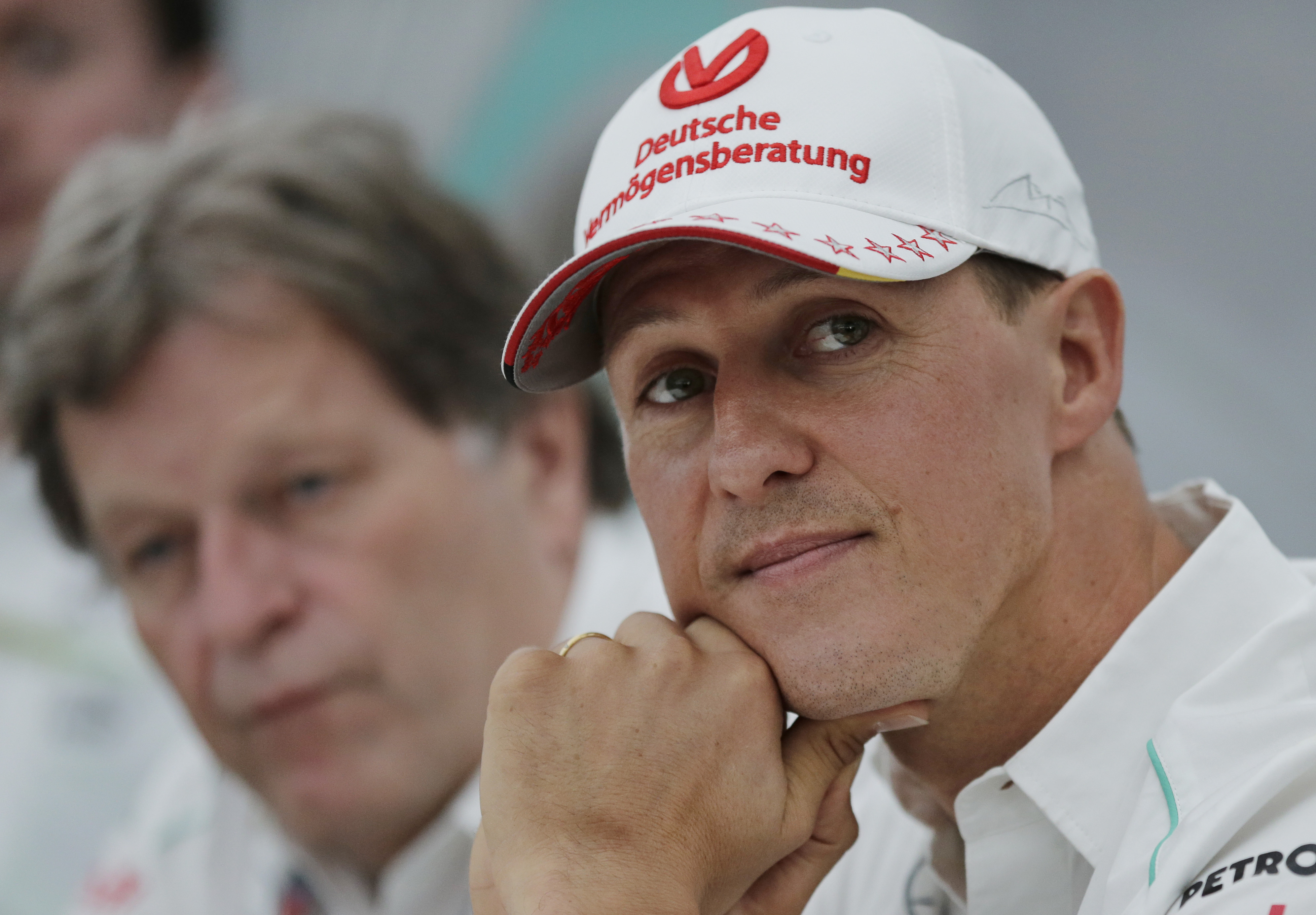 FILE - In this Thursday, Oct. 4, 2012 file photo, former Mercedes F1 driver Michael Schumacher of Germany pauses during a news conference to announce his retirement from Formula One at the end of  2012  in Suzuka, Japan.  Former Formula One world champion Michael Schumacher has left hospital to continue his recovery at home, his manager said Tuesday. The seven-time champion suffered a serious head injury while skiing in France in December, resulting in him being put in a coma. (AP Photo/Shizuo Kambayashi, File) (AP)