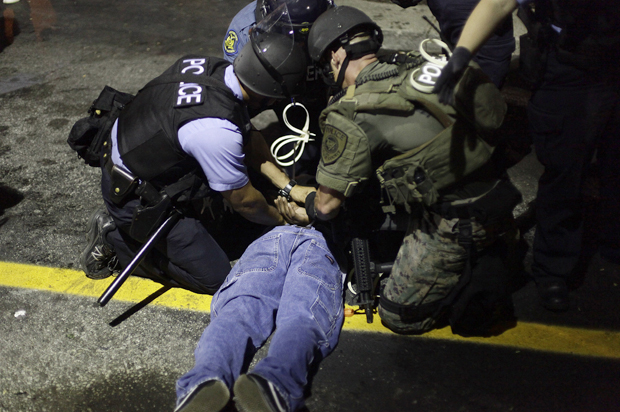 Police in riot gear detain a demonstrator in Ferguson, Missouri, Aug. 19, 2014. (Reuters/Joshua Lott)