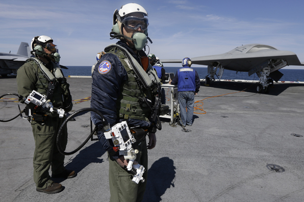 Northrop Grumman test pilots prepare to taxi the Navy X-47B drone, to be launched off the USS George H. W. Bush. (AP/Steve Helber)