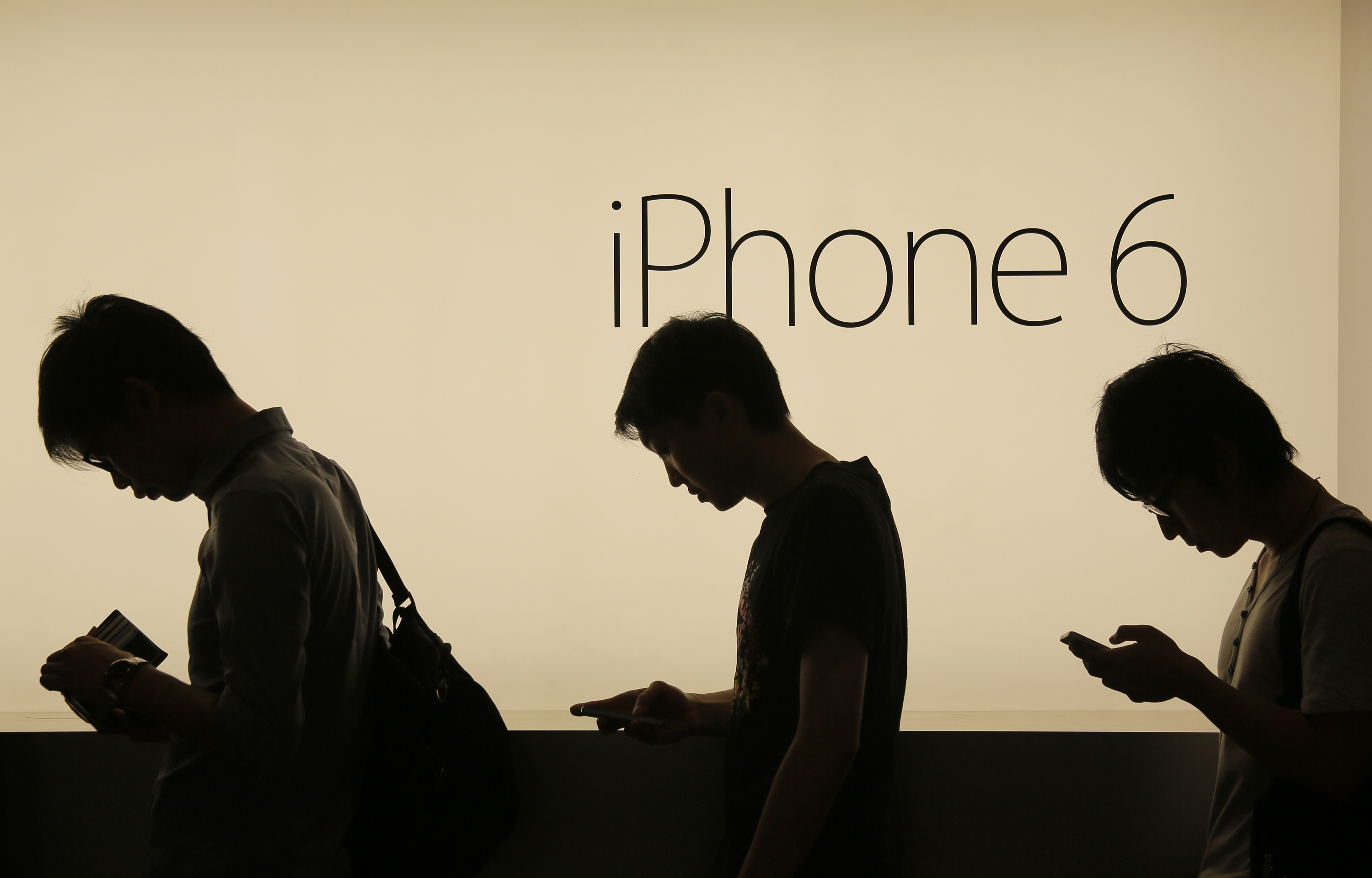 People wait to buy the new Apple iPhone 6 and 6 Plus devices, outside an Apple store in Hong Kong Friday morning, Sept. 19, 2014. The iPhone 6 and 6 Plus were released on Friday in Hong Kong. (AP Photo/Vincent Yu) (AP)