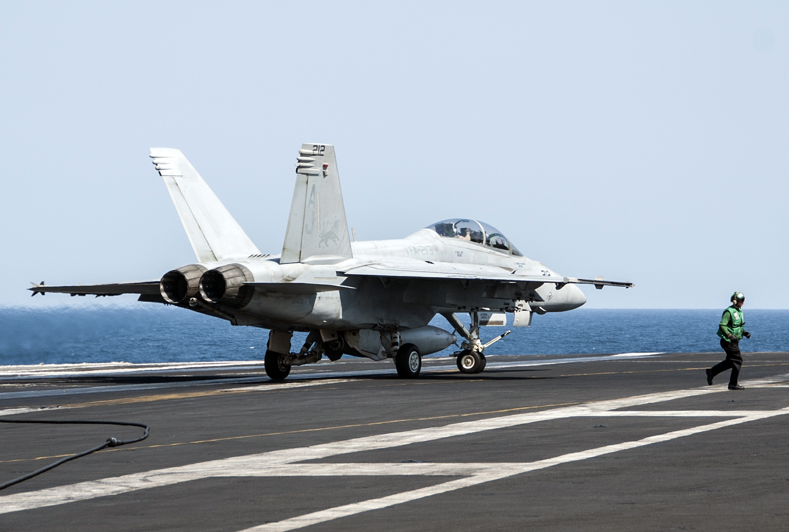 In this image provided by the U.S. Navy a F/A-18F Super Hornet attached to the Fighting Black Lions of Strike Fighter Squadron lands aboard the aircraft carrier USS George H.W. Bush in the Persian Gulf on Tuesday, Sept. 23, 2014, after conducting strike missions against Islamic State group targets in Syria. (AP Photo/U.S. Navy, Mass Communication Specialist 3rd Class Brian Stephens) (AP)