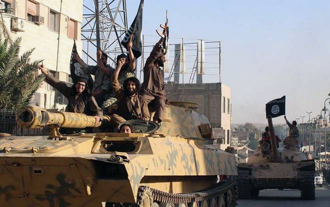 Fighters from the Islamic State group parade in Raqqa, Syria. (AP/Raqqa Media Center of the Islamic State group)