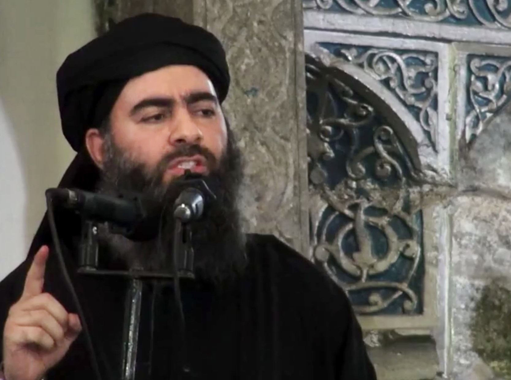FILE - This Saturday, July 5, 2014 file image made from video posted on a militant website which has been authenticated based on its contents and other AP reporting, purports to show the leader of the Islamic State group, Abu Bakr al-Baghdadi, delivering a sermon at a mosque in Iraq. In an audio speech released in July, the groups leader, al-Baghdadi, listed instances of alleged oppression of Muslims around the world, describing the Islamic State as one that will return your dignity, might, rights and leadership. With its transnational agenda, the group has become a magnet for disenfranchised young Muslims from all over the world. (AP Photo/Militant video, File) (AP)