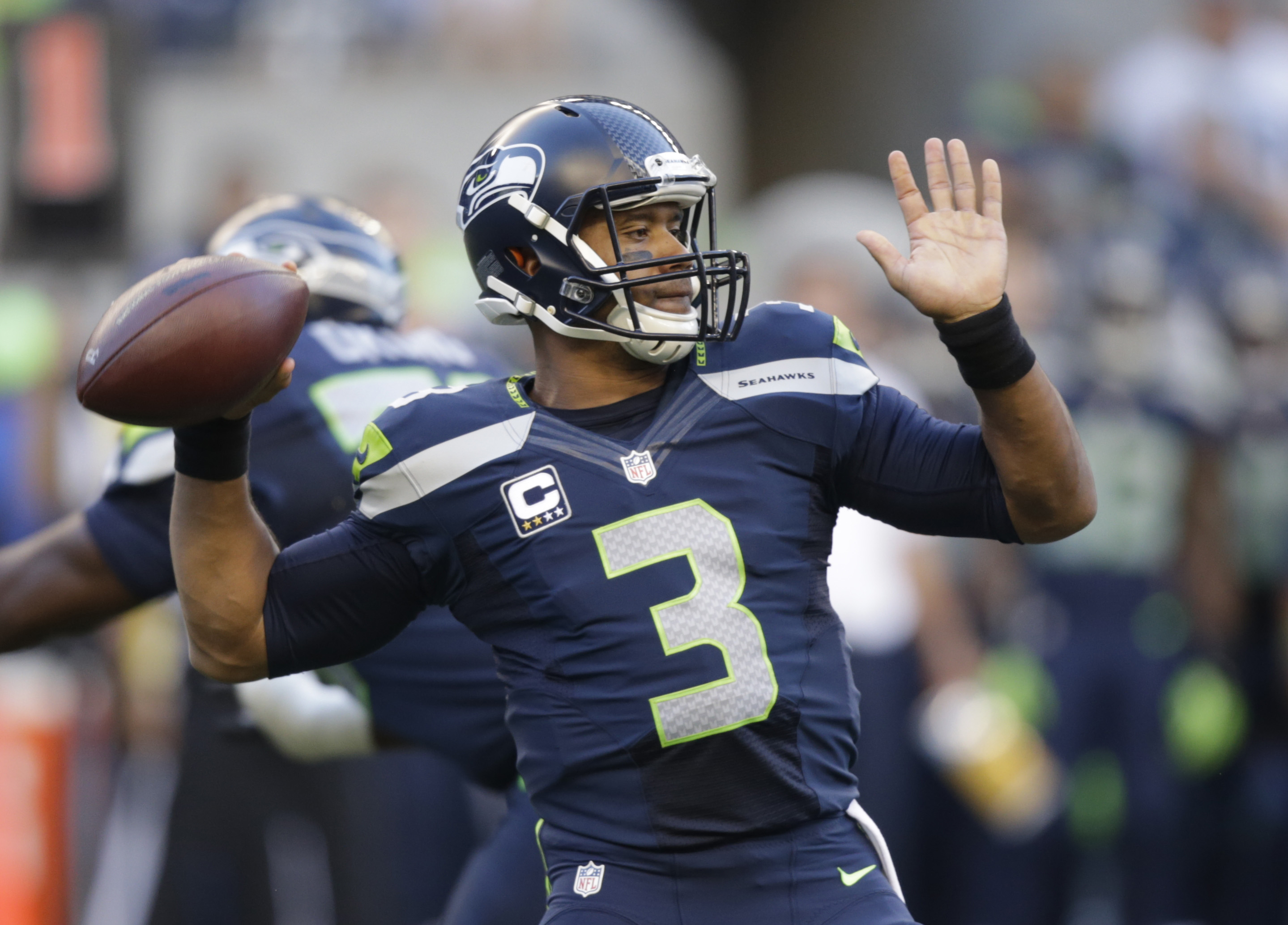 Seattle Seahawks quarterback Russell Wilson winds up to pass against the Green Bay Packers in the first half of an NFL football game, Thursday, Sept. 4, 2014, in Seattle. (AP Photo/Stephen Brashear) (AP)