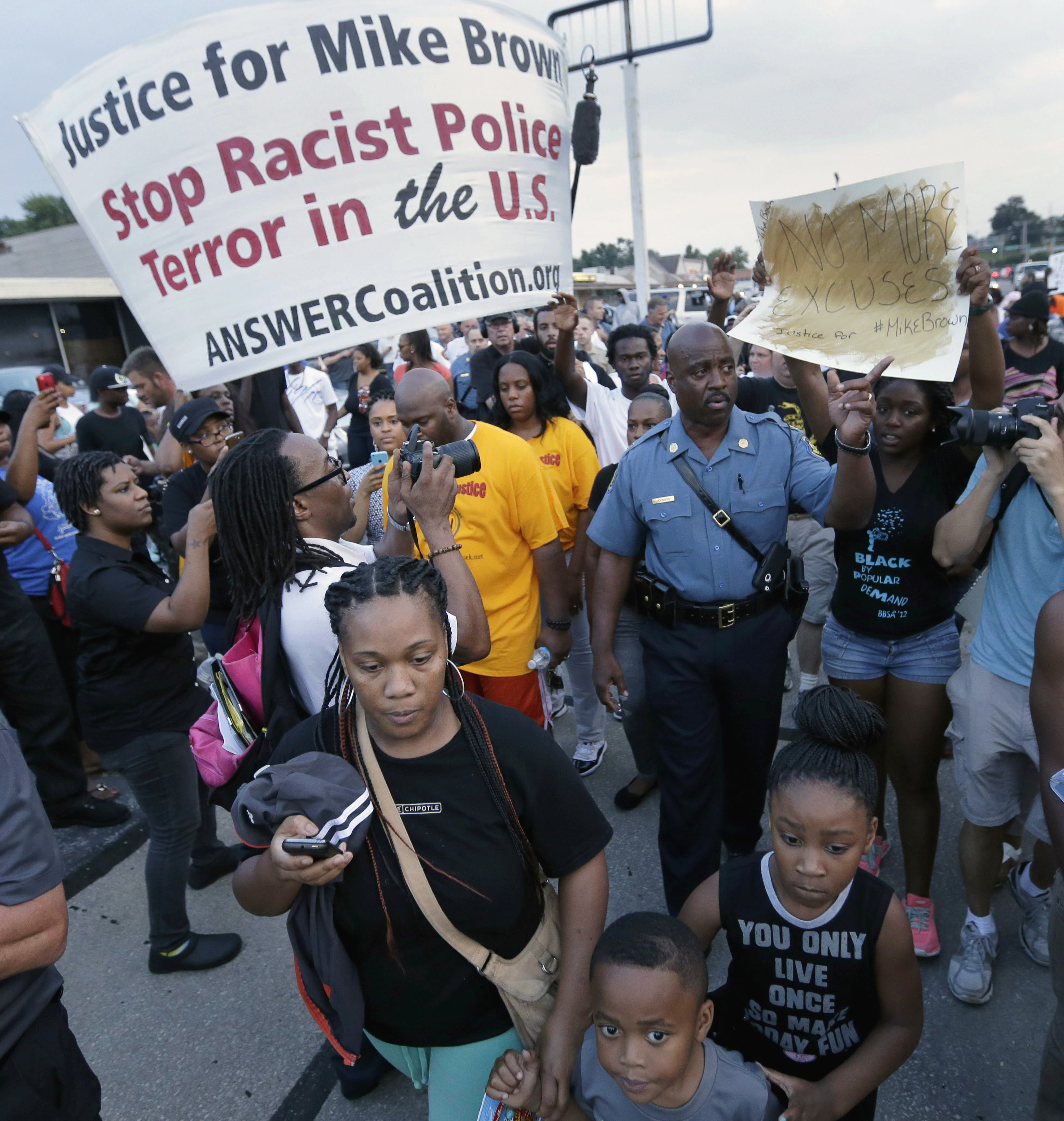 In this Aug, 16, 2014 file photo, Missouri Highway Patrol Capt. Ron Johnson walks among people protesting the police shooting death of Michael Brown a week ago in Ferguson, Mo. The Ferguson City Council, set to meet Tuesday, Sept. 9, 2014, for the first time since the fatal shooting of Brown, said it plans to establish a review board to help guide the police department and make other changes aimed at improving community relations. (AP/Charlie Riedel)
