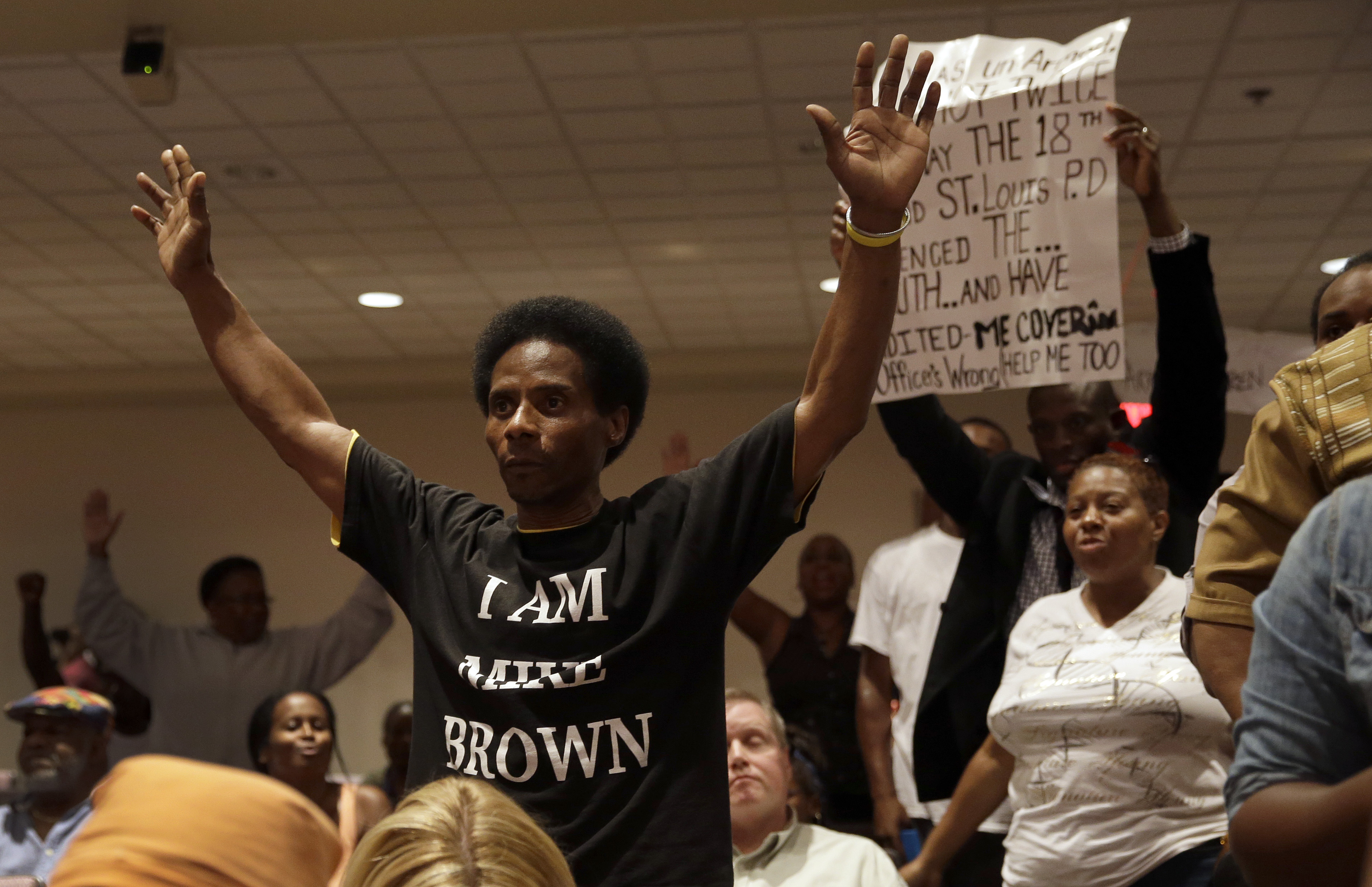 Larry Miller holds up his hands after speaking during a public comments portion of a meeting of the Ferguson City Council Tuesday, Sept. 9, 2014, in Ferguson, Mo. The meeting is the first for the city council since the fatal shooting of Michael Brown by a city police officer. (AP/Jeff Roberson)