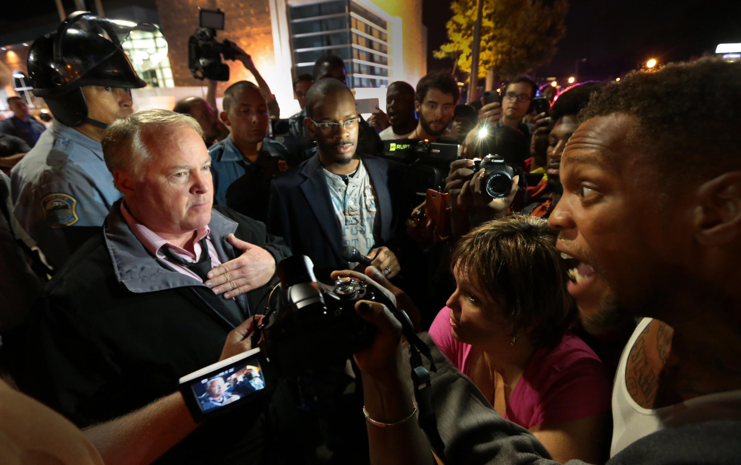 Ferguson Police Chief Tom Jackson, left, speaks before protesters in front of the Ferguson Police Department, on Thursday, Sept. 25, 2014. (AP Photo/St. Louis Post-Dispatch, Robert Cohen) (AP/St. Louis Post-Dispatch, Robert Cohen)