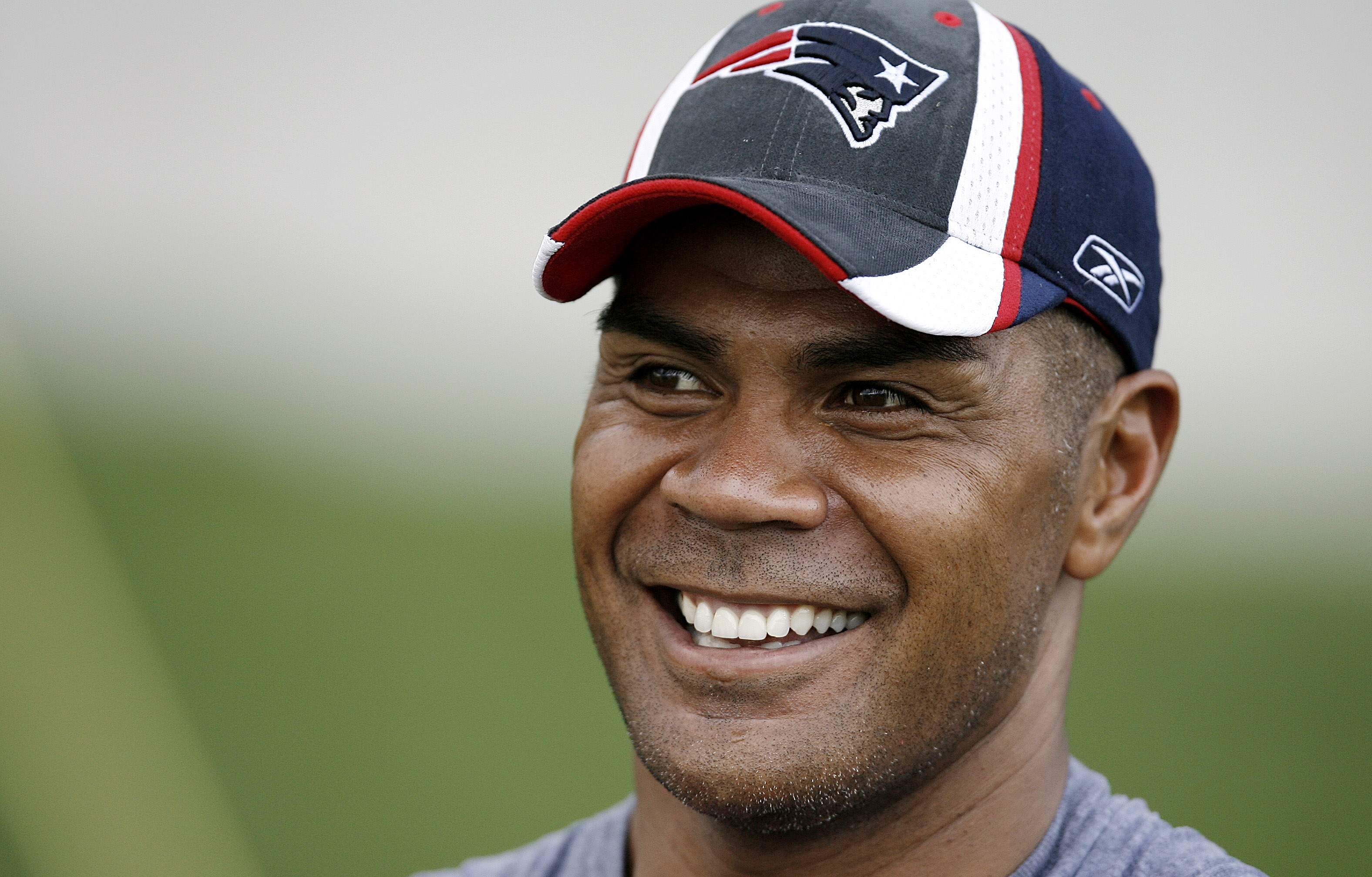 New England Patriots linebacker Junior Seau smiling during NFL football training camp in Foxborough, Mass. Seau, a star linebacker for 20 seasons who made 11 Pro Bowls, committed suicide in 2012. (AP)