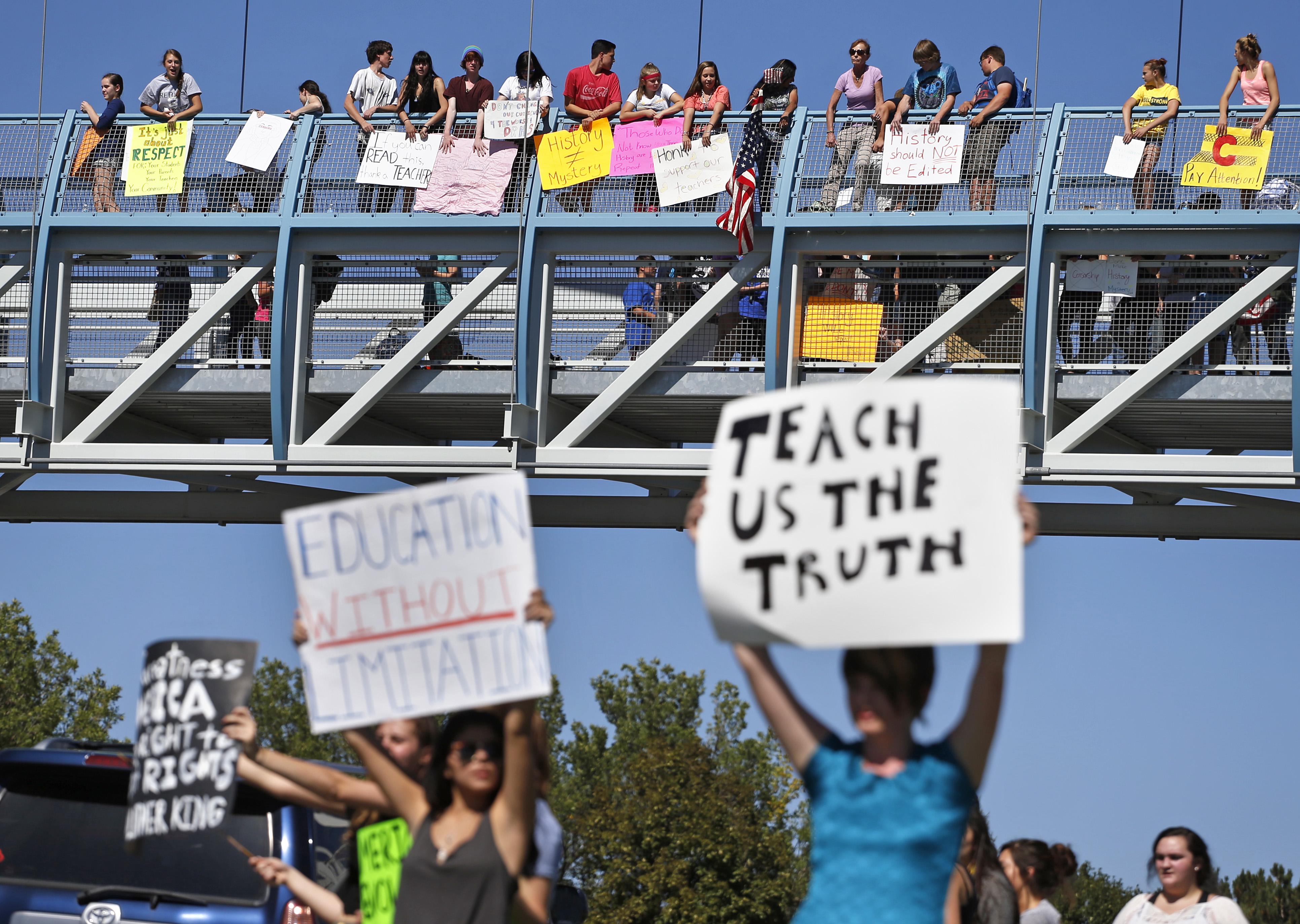 Students line a busy intersection and overpass protesting against a Jefferson County School Board proposal to emphasize patriotism and downplay civil unrest in the teaching of U.S. history, in the Denver suburb of Littleton, Colo., Thursday, Sept. 25, 2014. Several hundred students walked out of class Thursday in the fourth straight day of protests in Jefferson County. (AP Photo/Brennan Linsley) (AP)