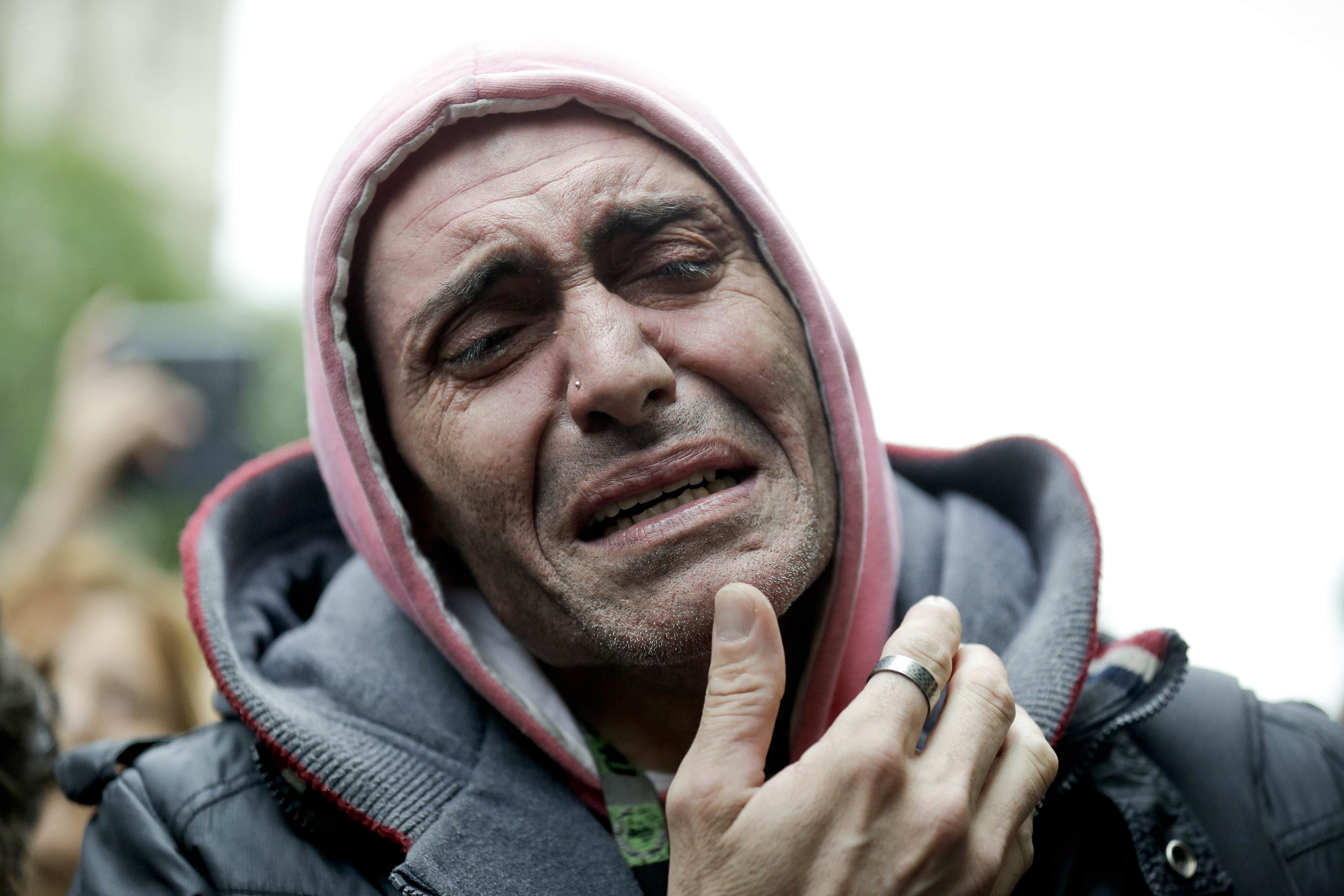 In this Friday, Sept. 5, 2014 photo, a man cries as mourners wait for the departure of the funeral car transporting the remains of Argentine rock star Gustavo Cerati to a cemetery, in Buenos Aires, Argentina. Cerati died on Thursday, four years after a stroke put him in a coma and ended the career of one of Latin America's most influential musicians. (AP Photo/Victor R. Caivano) (AP)
