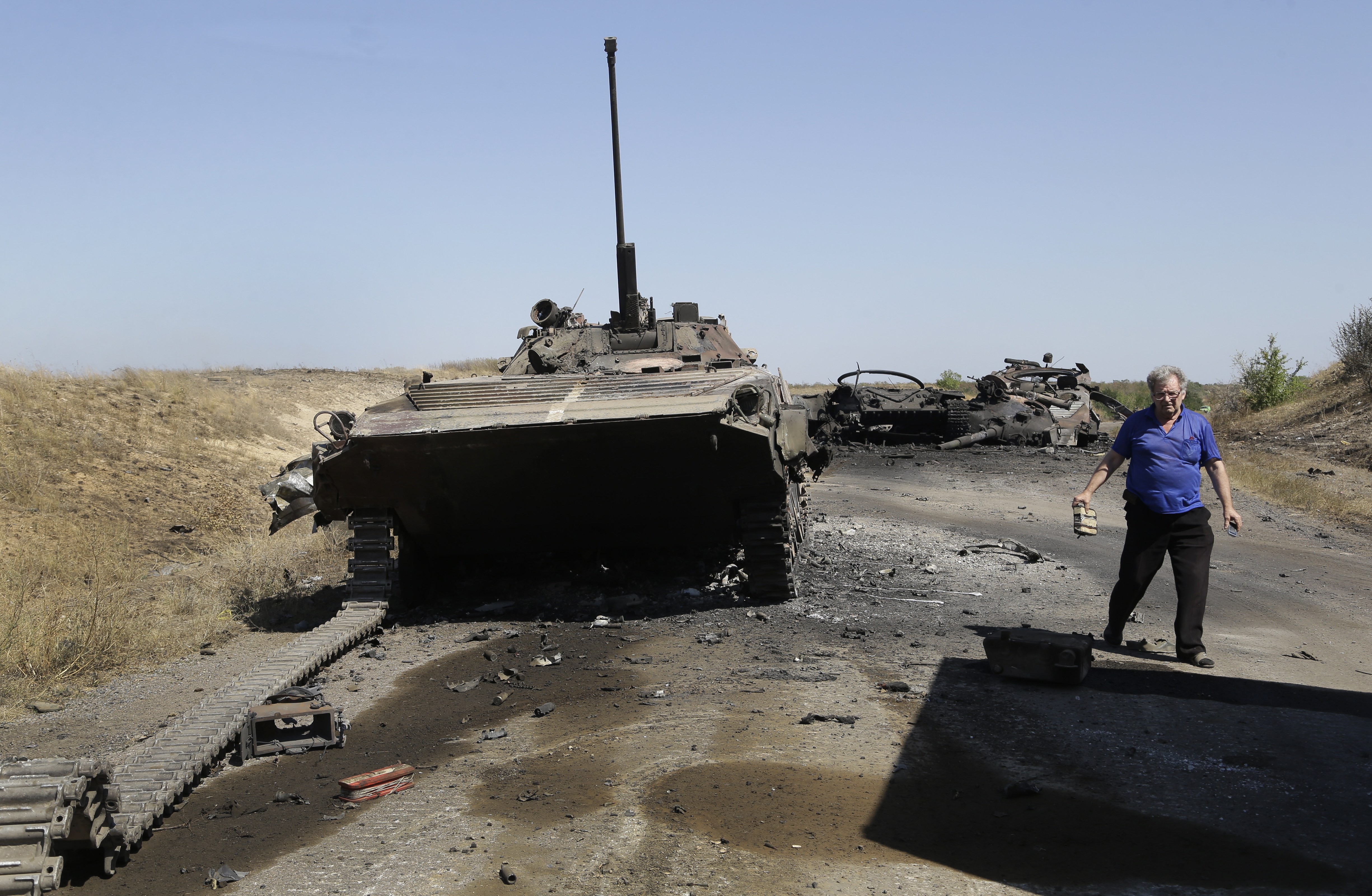 A column of destroyed Ukrainian military vehicles are seen near the village of Novokaterynivka, eastern Ukraine, Tuesday, Sept. 2, 2014. Ukrainian troops have over the past week suffered a string of major military losses in their offensive against Russian-backed separatist rebels, losing large swathes of territory and having hundreds of soldiers captured. (AP Photo/Sergei Grits) (AP)
