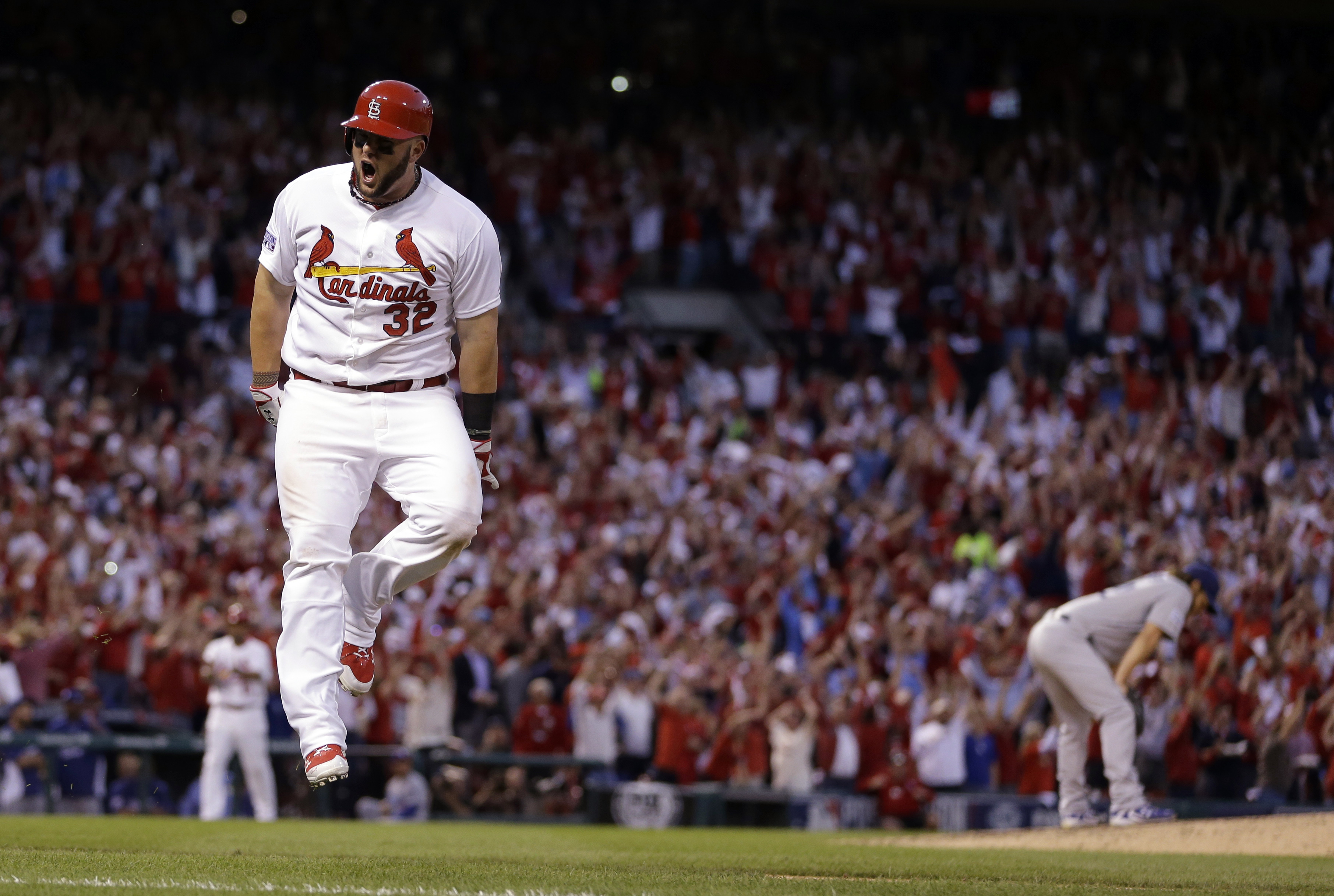 St. Louis Cardinals' Matt Adams celebrates after hitting a three-run home off Los Angeles Dodgers starting pitcher Clayton Kershaw, right, during the seventh inning of Game 4 of baseball's NL Division Series, Tuesday, Oct. 7, 2014, in St. Louis. The Cardinals won 3-2. (AP Photo/Jeff Roberson) (AP)
