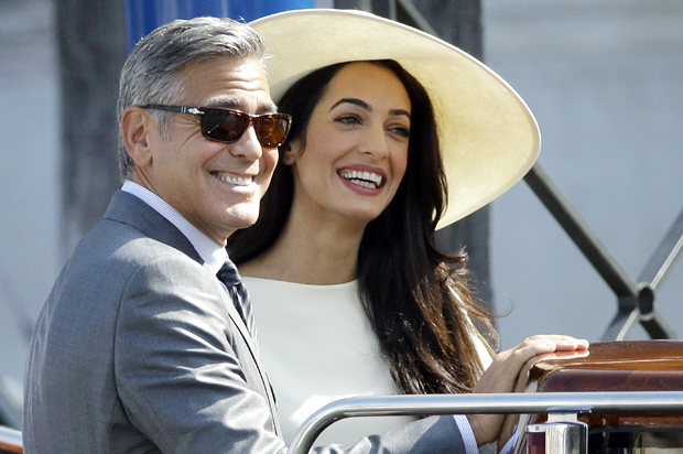 George Clooney and Amal Alamuddin leave Venice's city hall, Italy, Monday, Sept. 29, 2014. Clooney and Amal married Saturday, Sept. 27, the actor's representative said, out of sight of pursuing paparazzi and adoring crowds. (AP Photo/Andrew Medichini) (Andrew Medichini)