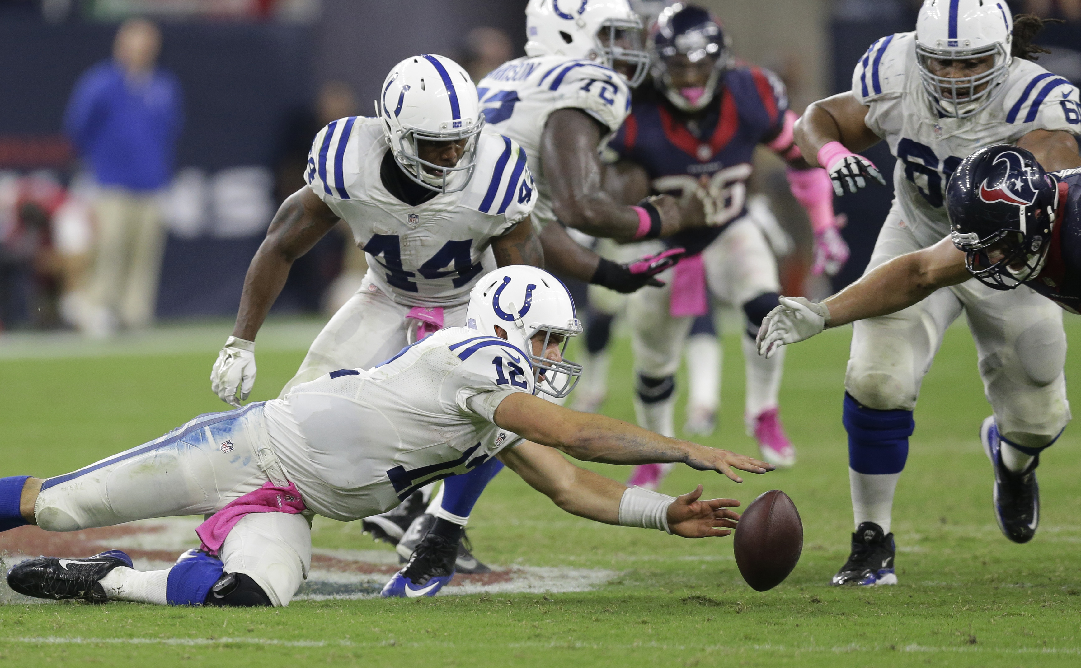 Indianapolis Colts' Andrew Luck (12) loses the ball during the second half of an NFL football game against the Houston Texans, Thursday, Oct. 9, 2014, in Houston. Houston's J.J. Watt recovered the ball and returned it for a 45-yard touchdown. (AP Photo/Patric Schneider) (AP)