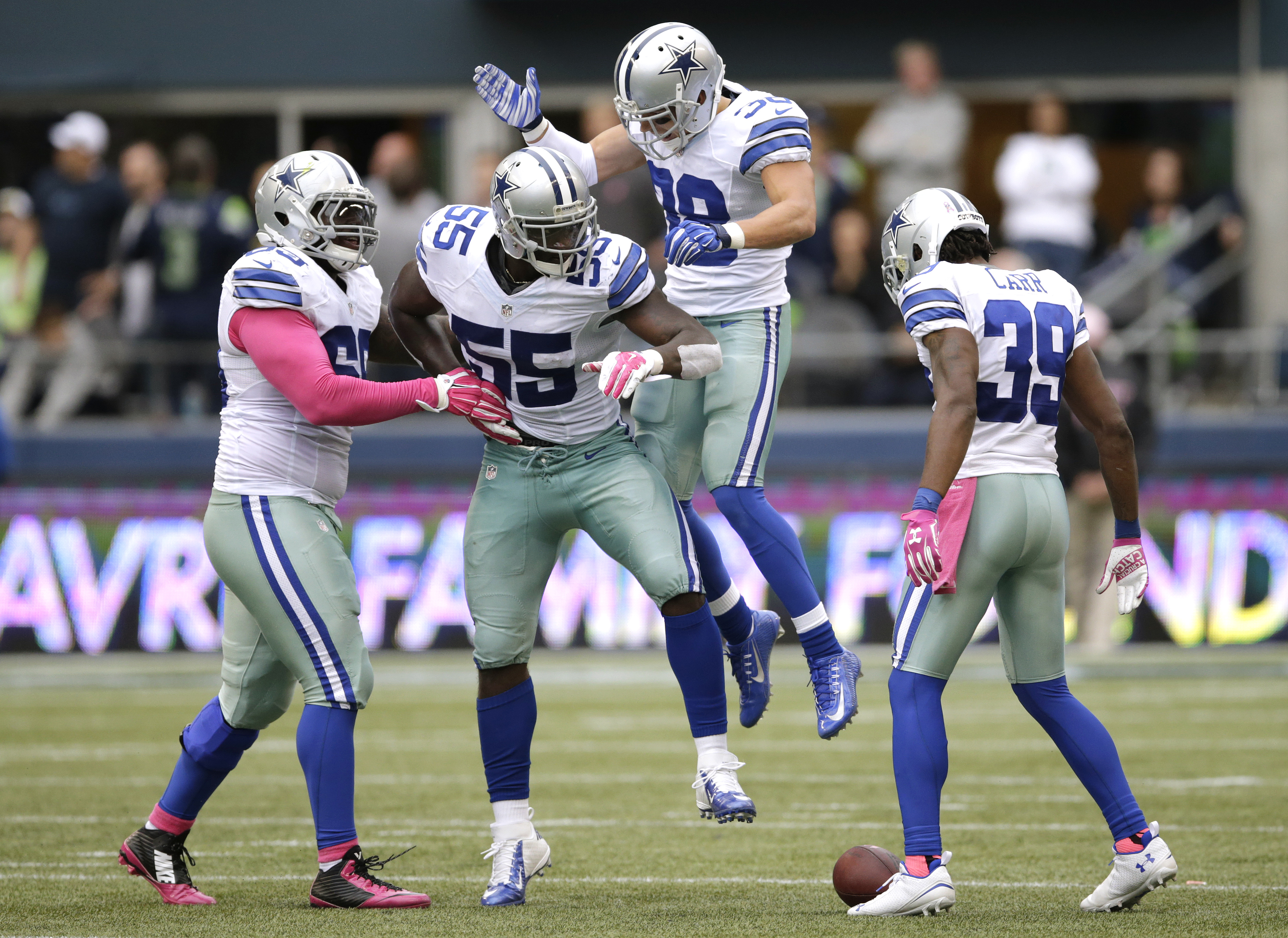 Dallas Cowboys middle linebacker Rolando McClain (55) celebrates with teammates after he intercepted a pass late in the second half of an NFL football game against the Seattle Seahawks, Sunday, Oct. 12, 2014, in Seattle. The Cowboys won 30-23. (AP Photo/Scott Eklund) (AP)