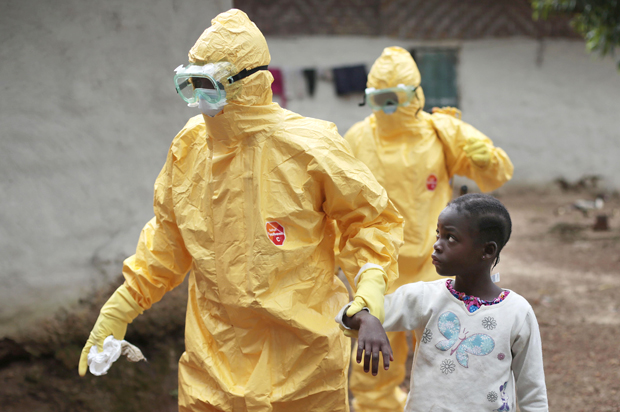 Nowa Paye, 9, is taken to an ambulance after showing signs of the Ebola infection in the village of Freeman Reserve, Liberia, Sept. 30, 2014. (AP/Jerome Delay)