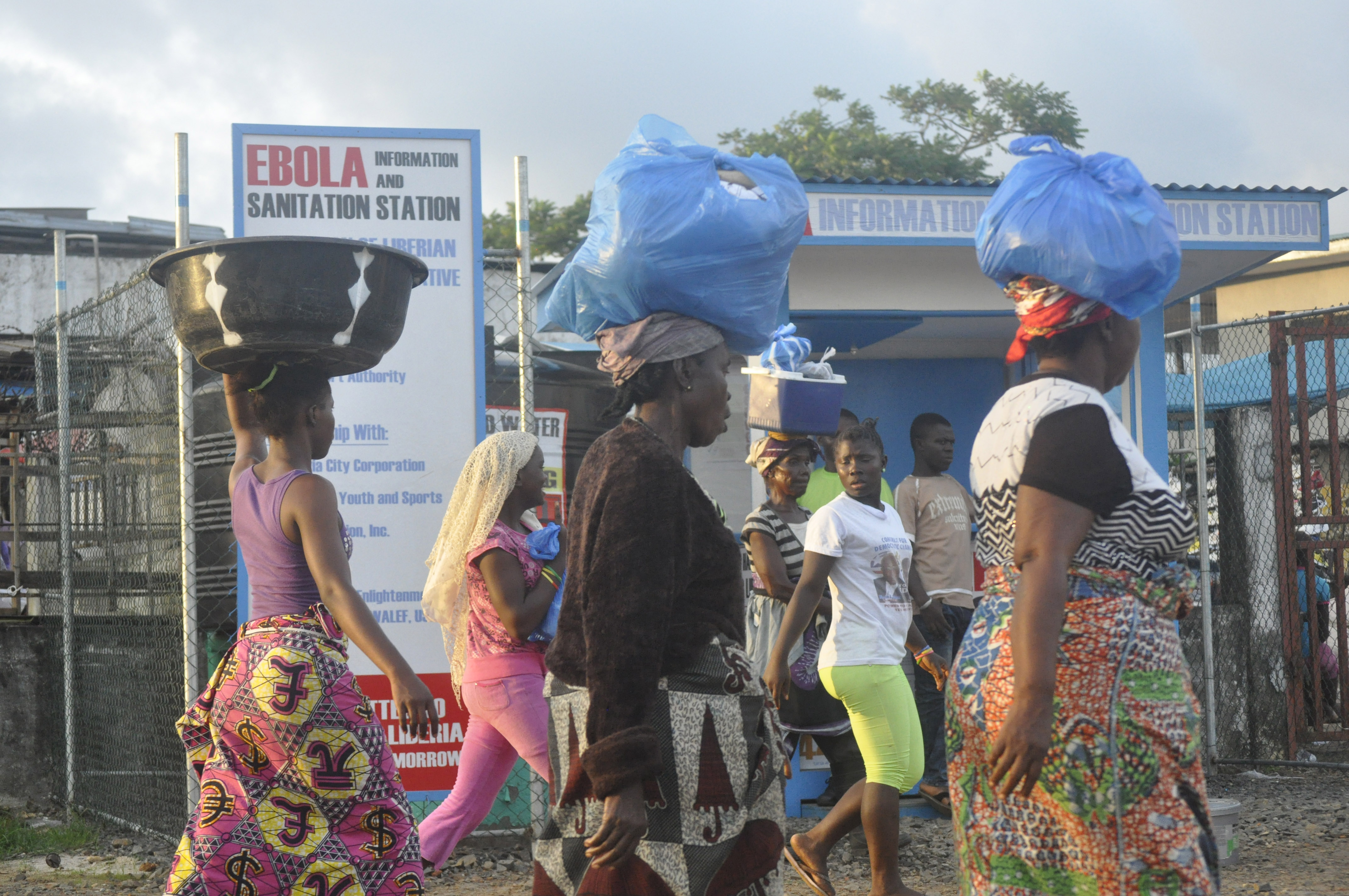 Liberia women walk past a sign warning people of the deadly Ebola virus in Monrovia, Liberia. Friday, Oct. 10, 2014. The number of people killed in the Ebola outbreak has risen above 4,000, according to the World Health Organization.  (AP Photo/ Abbas Dulleh) (AP)