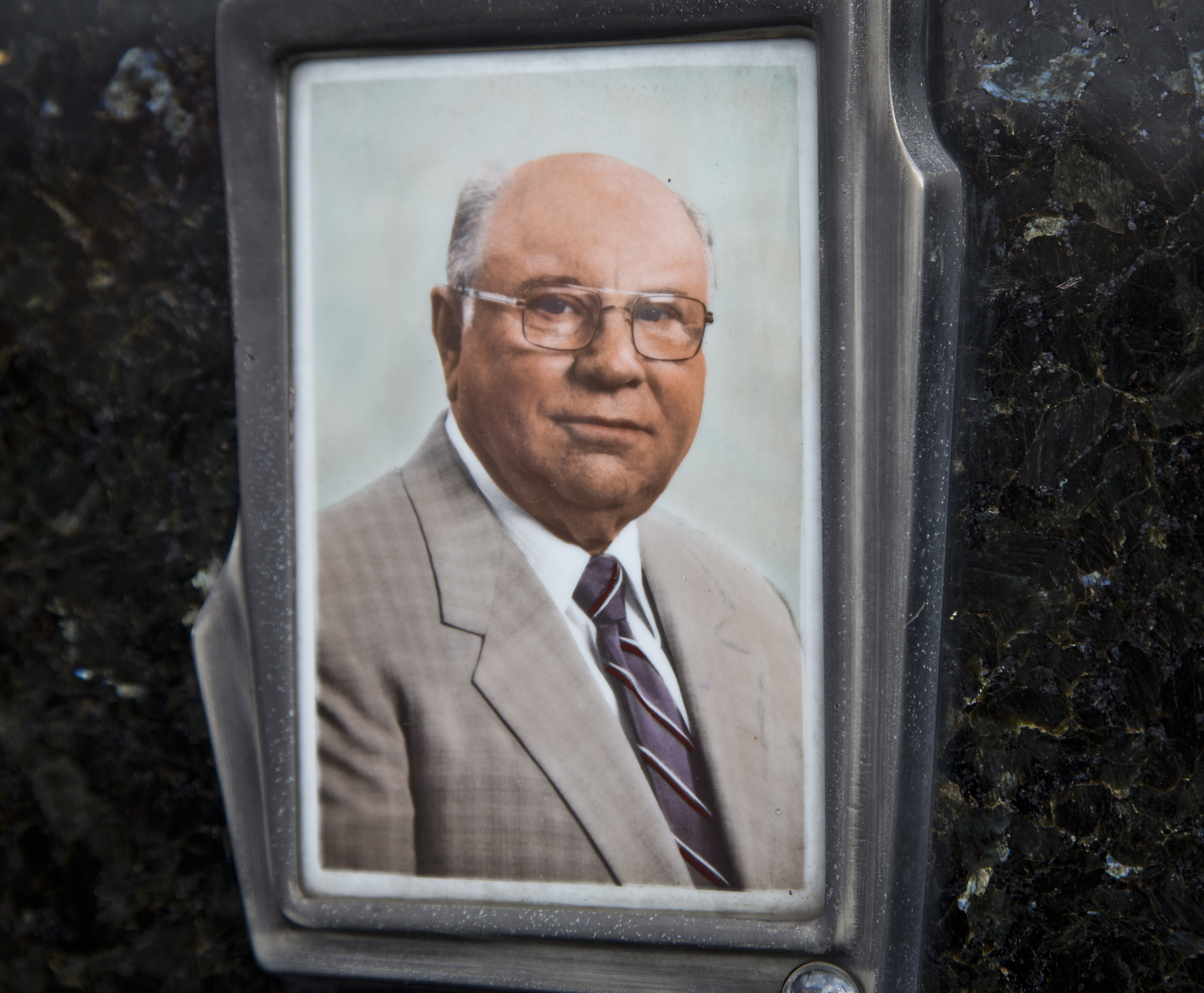 This July 28, 2014, photo shows Jakob Denzinger's portrait on the tombstone of his empty grave in Cepin eastern Croatia. Denzinger is among dozens of death camp guards and suspected Nazi war criminals who collected millions of dollars in Social Security payments despite being forced out of the United States according to an Associated Press investigation. (AP Photo/Darko Bandic) (AP)