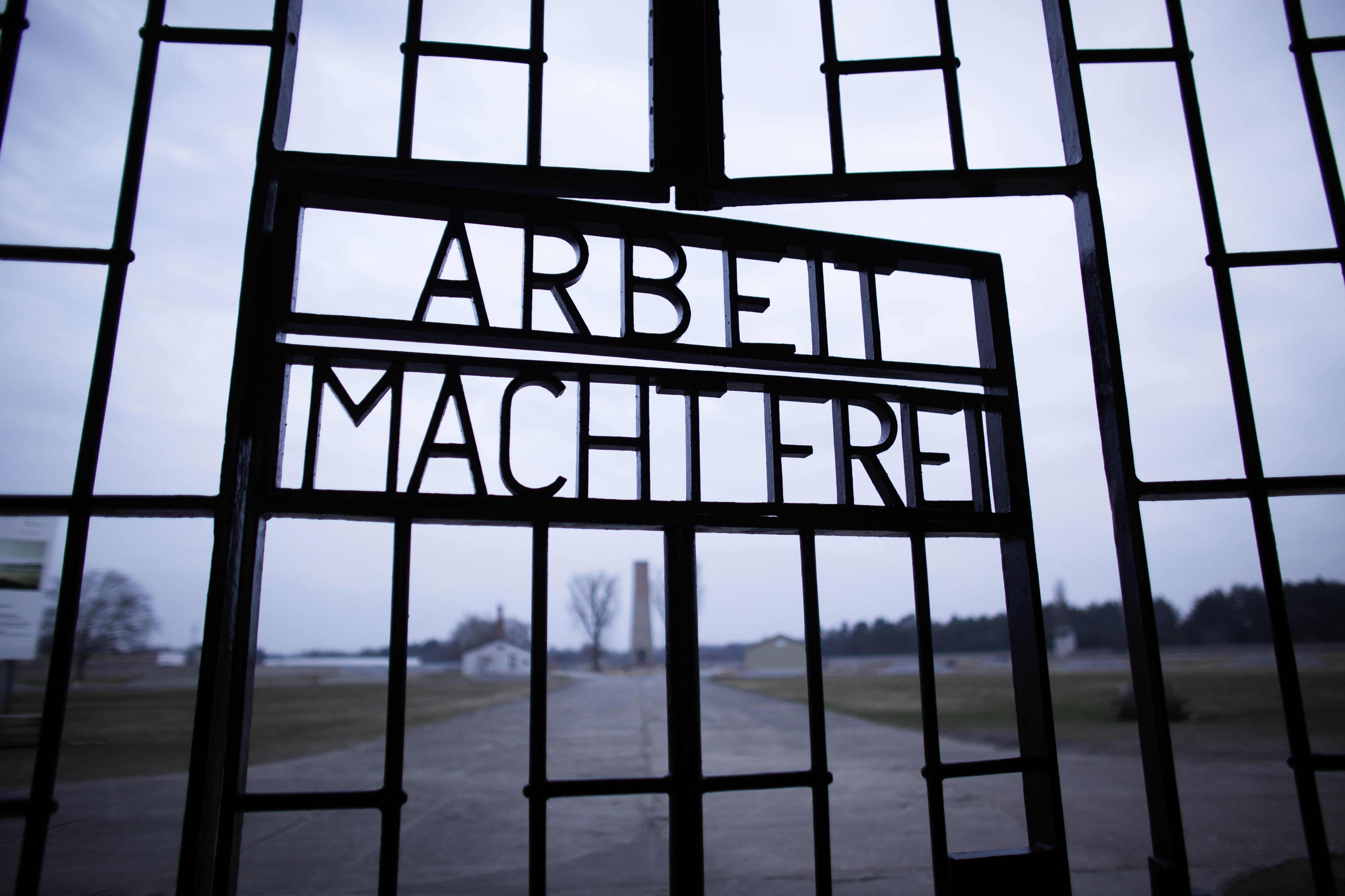 FILE - This Jan. 27, 2012, file photo shows the words 'Arbeit Macht Frei' (Work Sets You Free) at the main entrance of the Sachsenhausen Nazi concentration camp on the international Holocaust remembrance day in Oranienburg, Germany. An Associated Press investigation found dozens of suspected Nazi war criminals and SS guards collected millions of dollars in Social Security payments after being forced out of the United States. (AP/Markus Schreiber)