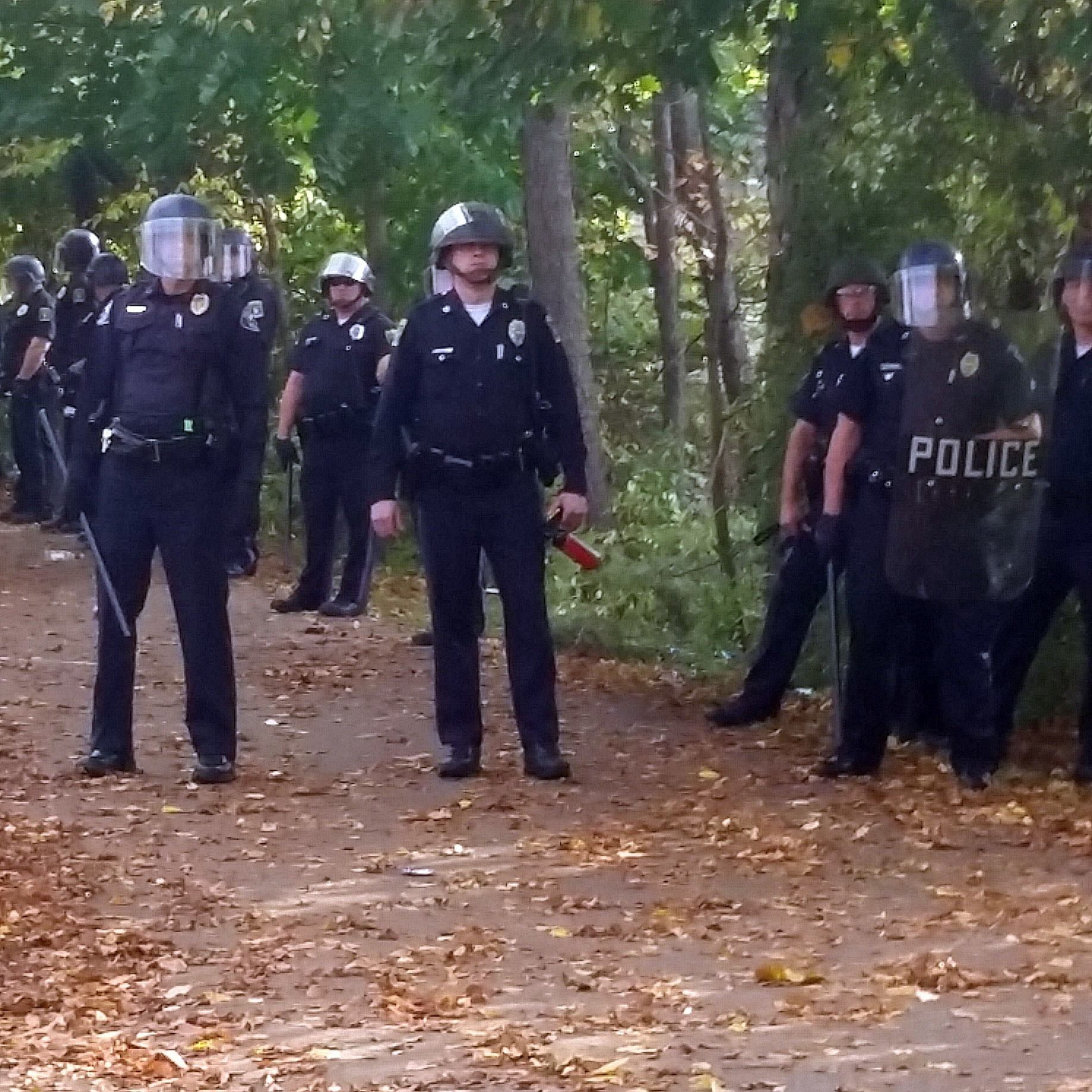 In this photo provided by Seth Meyer police officers line up. Local police, firefighters and ambulances in New Hampshire responded to large crowds of students as the annual Pumpkin Festival is underway near Keene State College Saturday, Oct. 18, 2014. (AP/Seth Meyer)