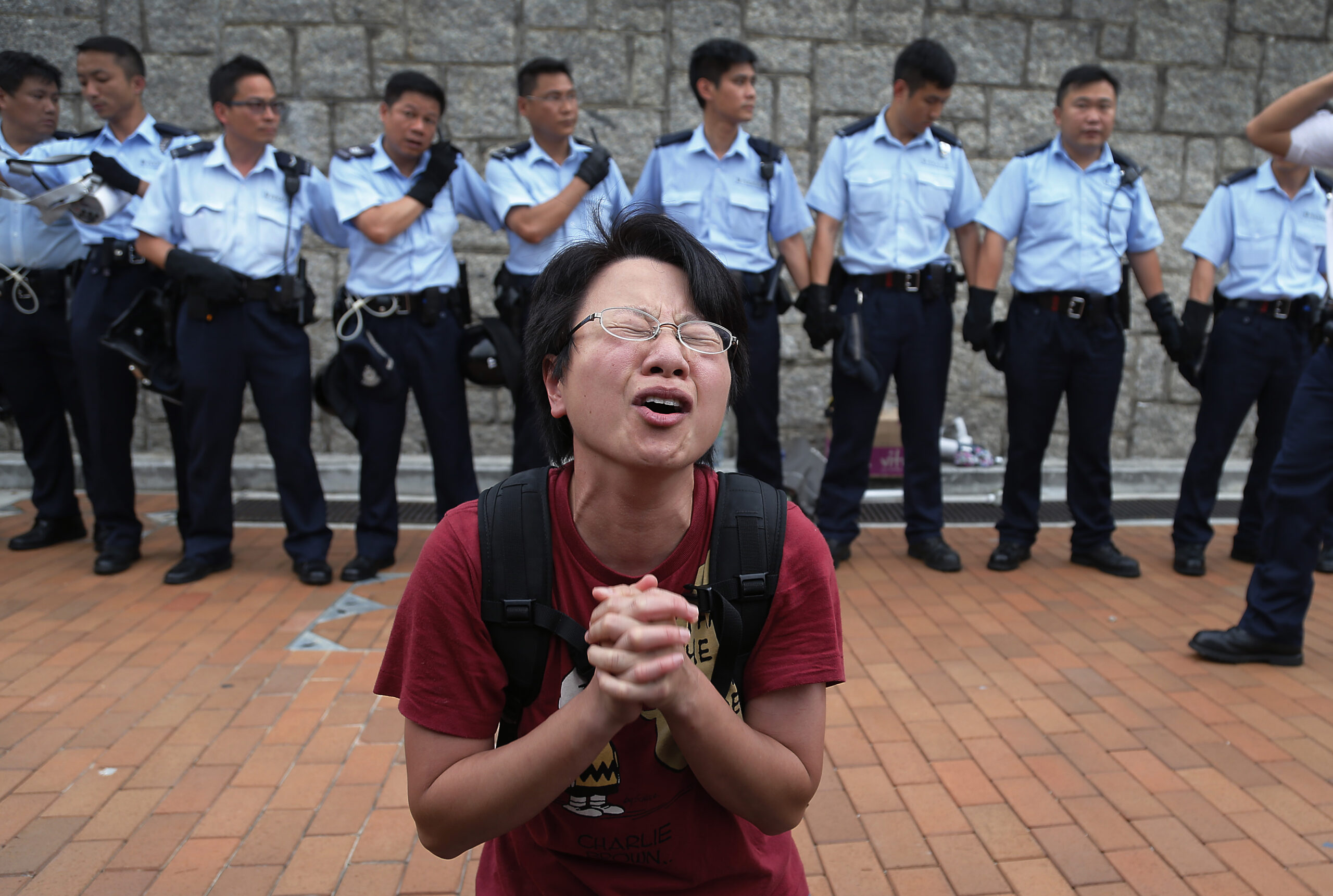 A student protester gets emotional while pleading for a peaceful resolution as some others resist during a change of shift for local police but backed down after being reassured they could reoccupy the pavement outside the government compoundâs gate, Thursday, Oct. 2, 2014 in Hong Kong. Hong Kong police warned of serious consequences if pro-democracy protesters try to occupy government buildings, as they have threatened to do if the territory's leader doesn't resign by Thursday. (AP Photo/Wong Maye-E) (Wong Maye-e)