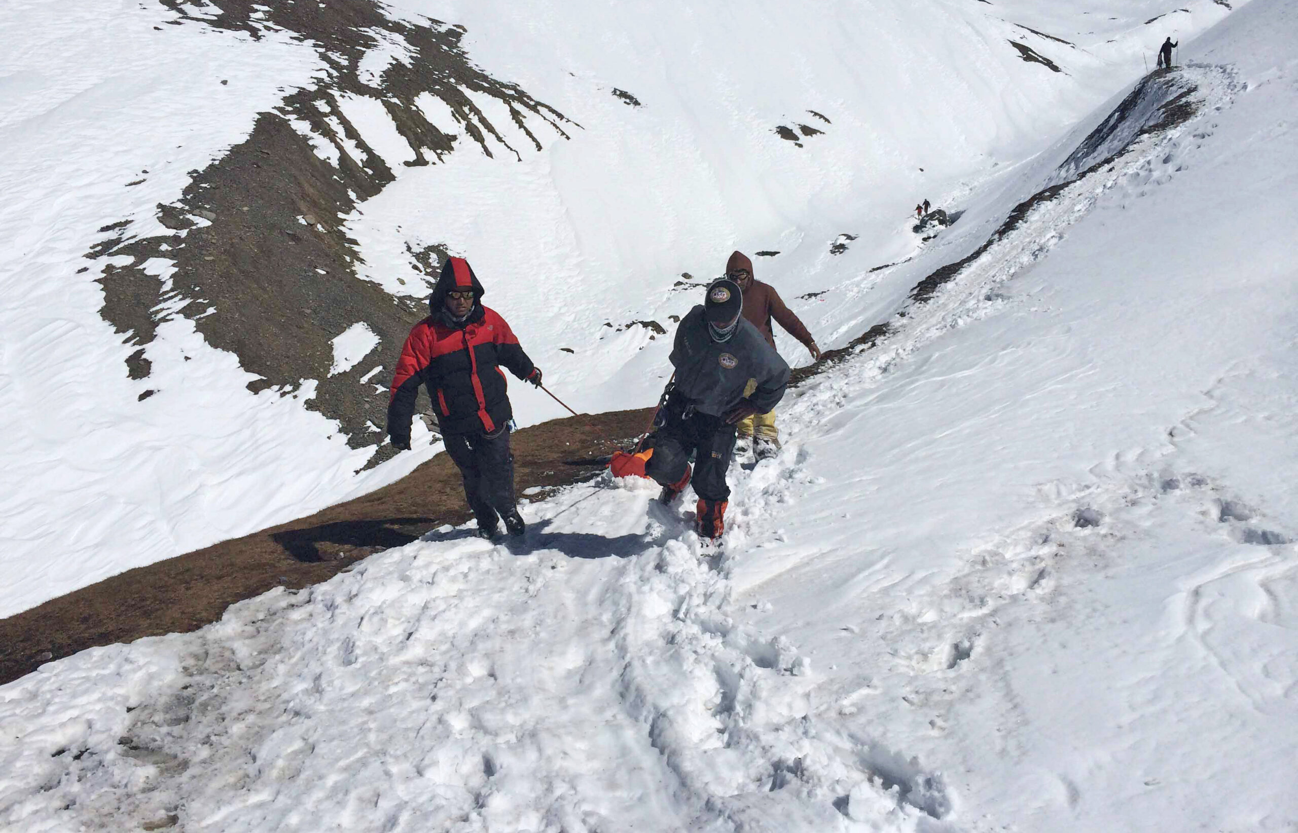 In this Friday, Oct. 17, 2014,  handout photo provided by the Nepalese army, rescue team members carry the body of an avalanche victim at Thorong La pass area in Nepal. Rescuers widened their search Friday for trekkers stranded since a series of blizzards and avalanches battered the Himalayas in northern Nepal early this week, leaving at least 29 foreigners and locals dead, officials said. (AP Photo/Nepalese Army) (AP)