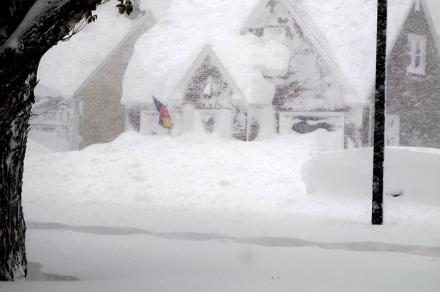 A house is obscured by wind-blown, lake-effect snow, Nov. 18, 2014 in Buffalo, N.Y. (AP/Carolyn Thompson)